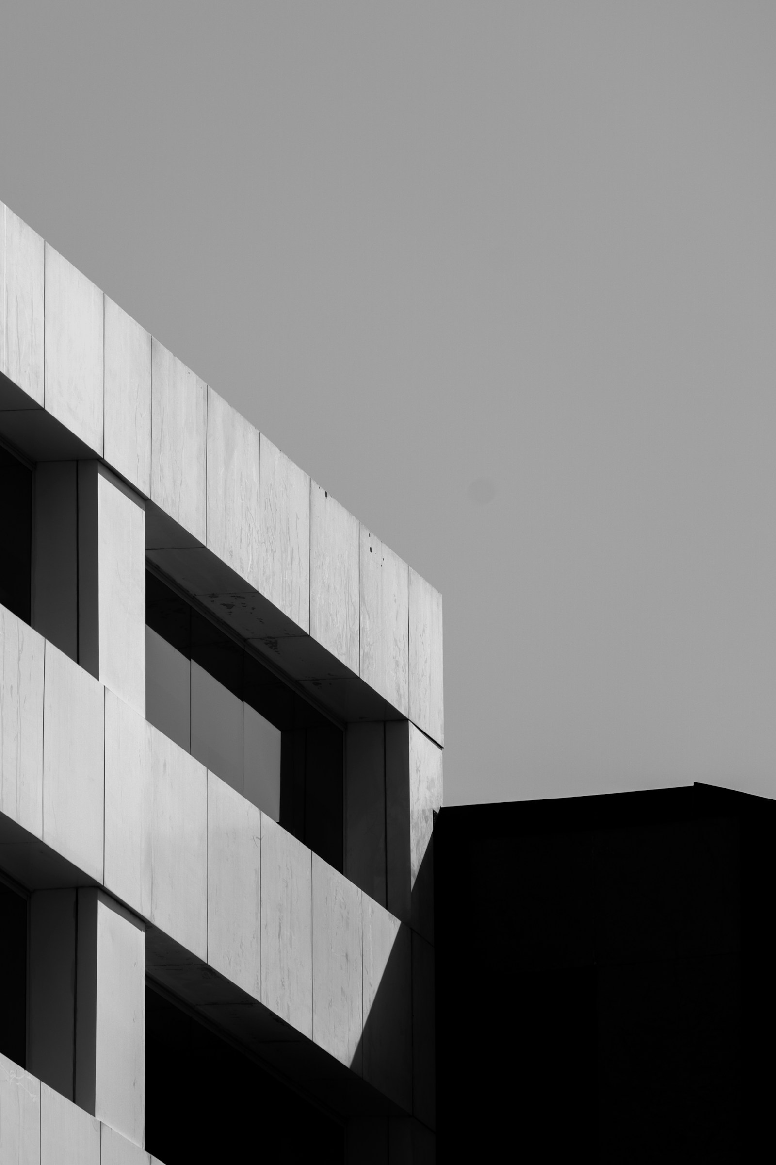 Black and white facade with deep window openings