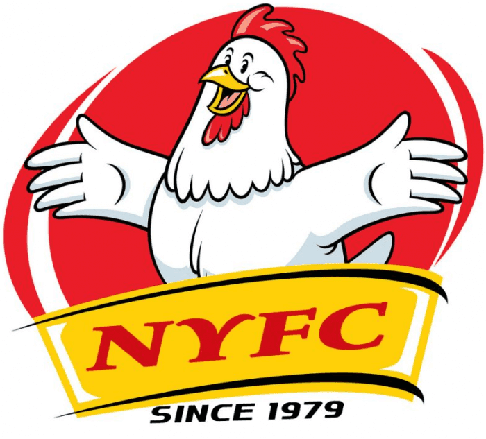 Close-up of a dark green leaf showing its textured surface and central vein against a muted background.