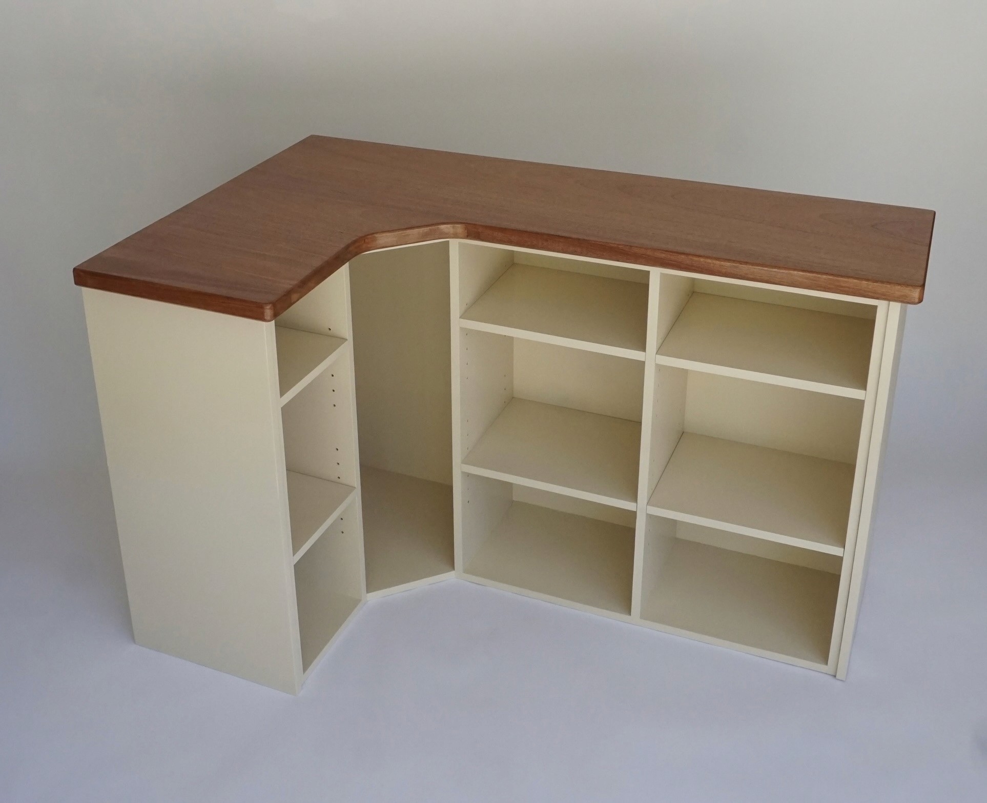 White L-shaped shelving unit with a wood countertop