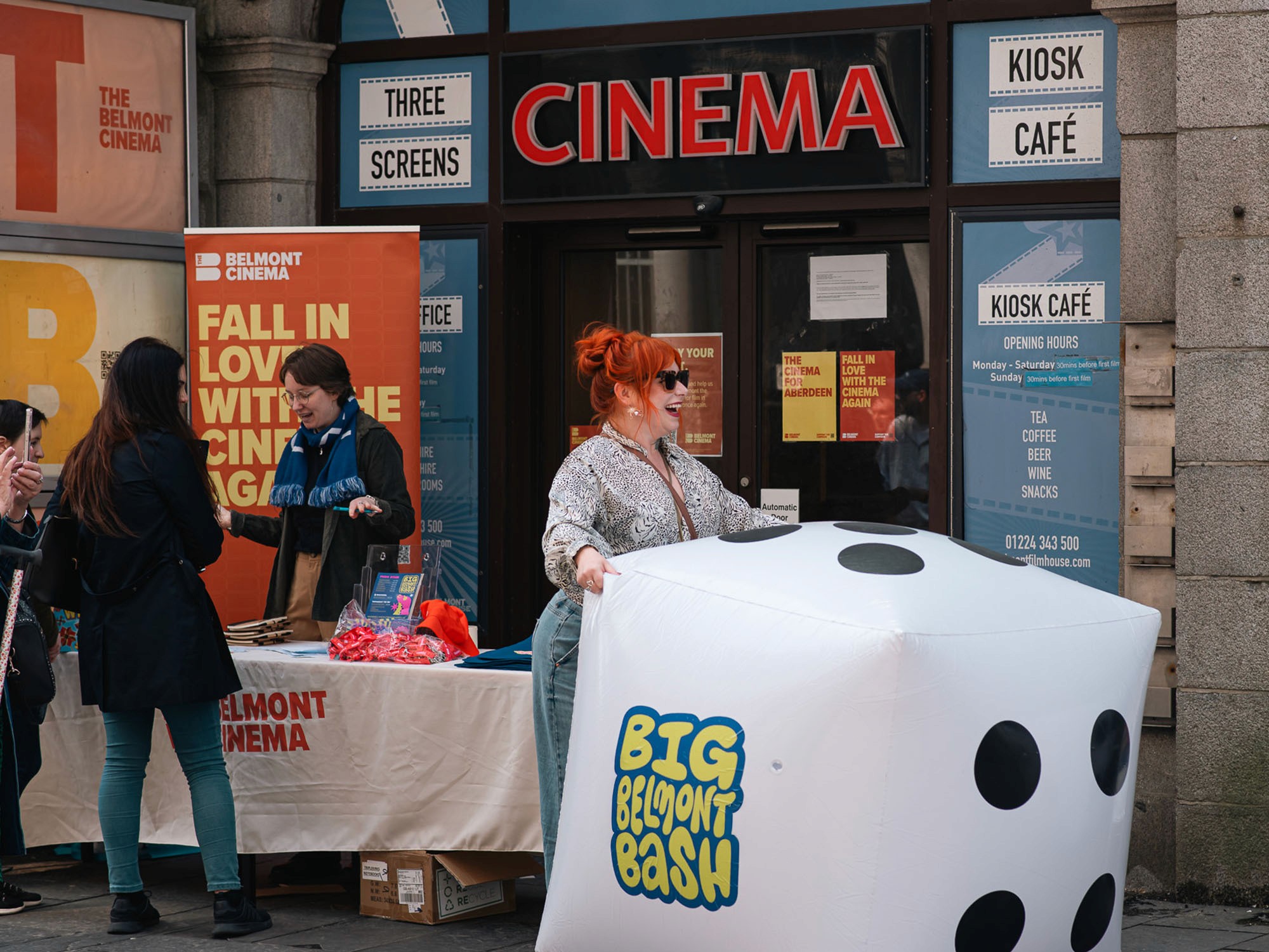 Woman rolling a giant dice in the street
