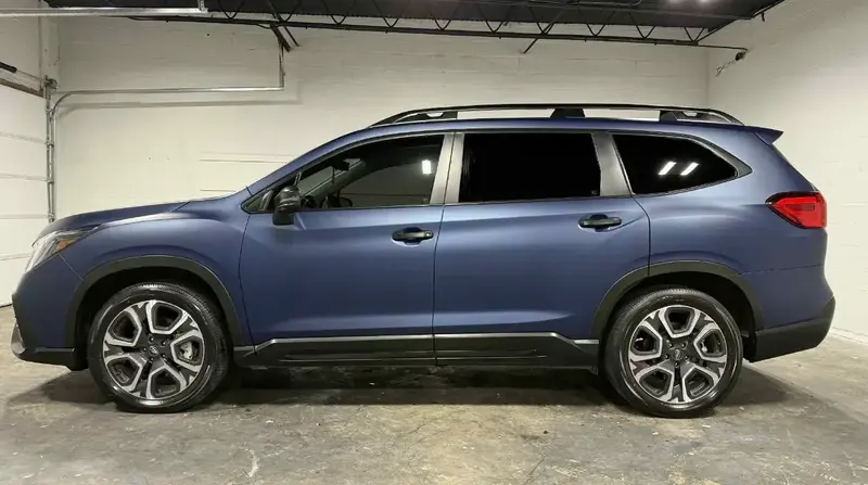 fresh blue car in shop with vinyl wrapping