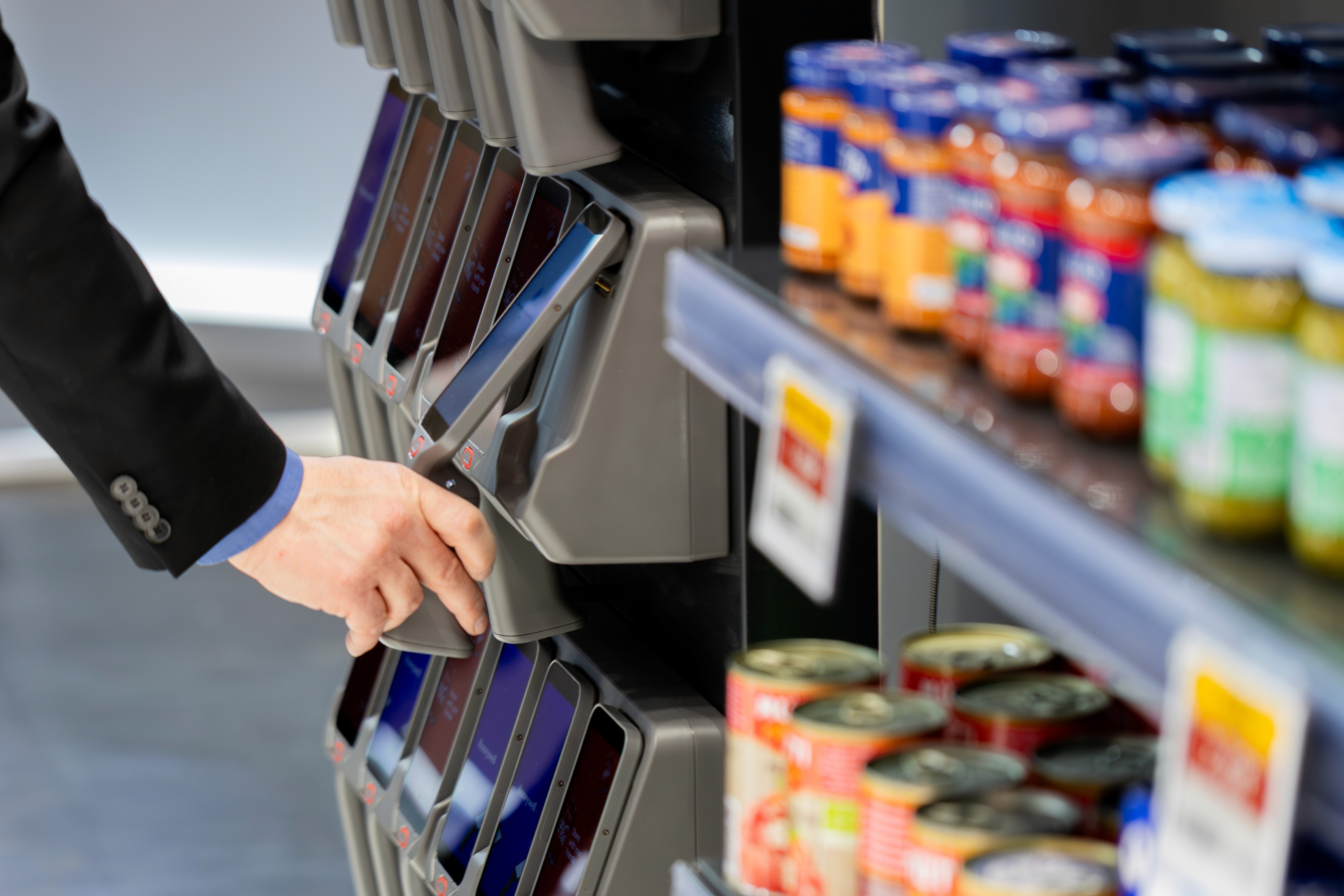 person taking out handheld scanner shopreme self-checkout software on honeywell cs32 handheld scanner