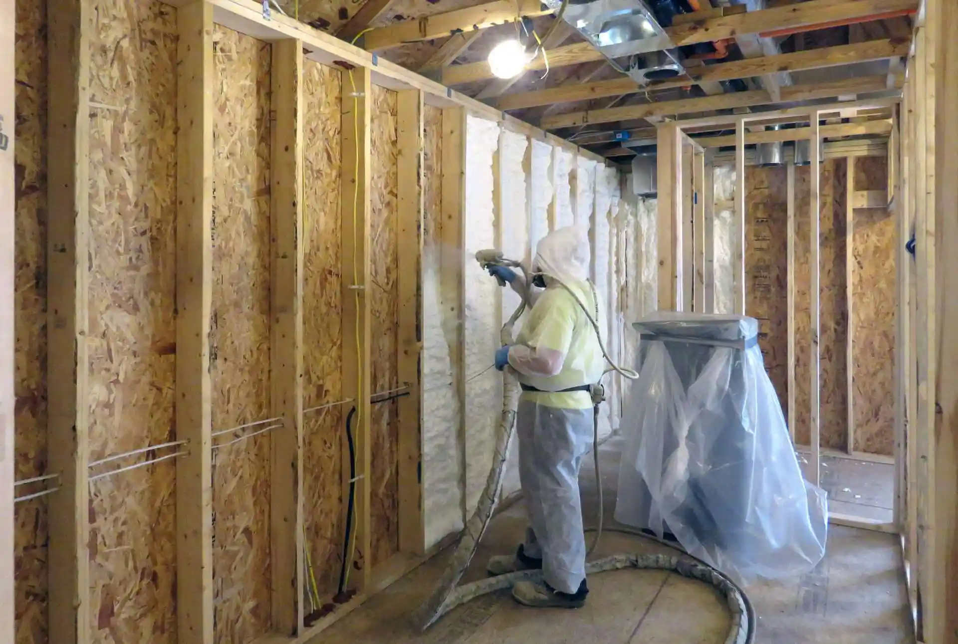 A technician spraying foam insulation in a St. Louis home