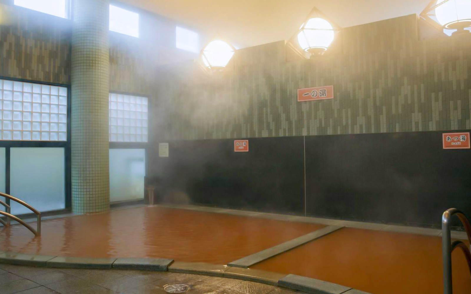 Indoor hot spring bath at Arima Onsen with steam rising, Kobe, Japan.