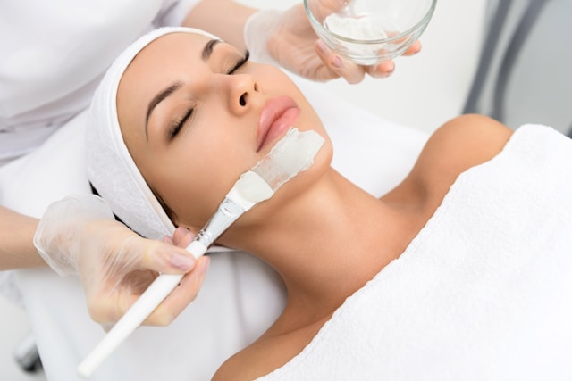 Face cream being applied to woman's face