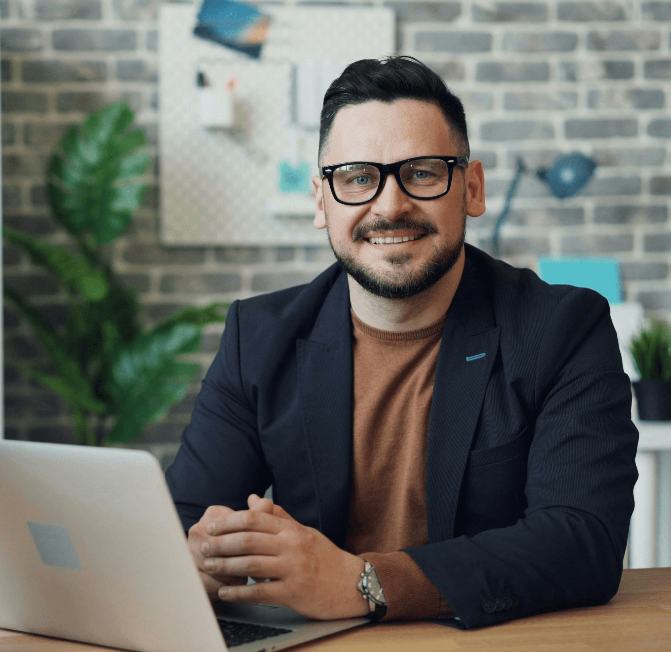 a man sitting at a table with a laptop