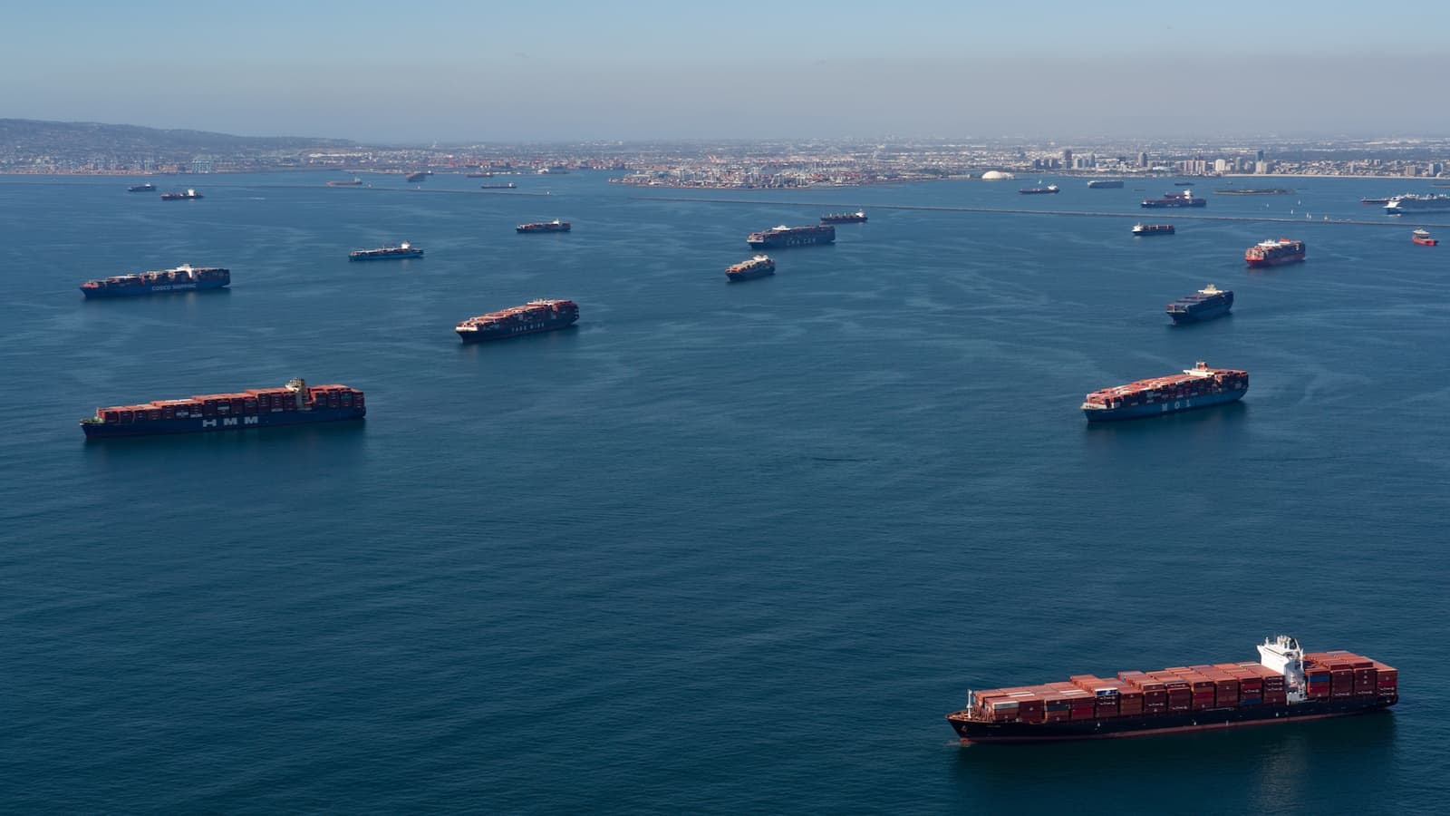 Container ships waiting to dock at a congested port, illustrating the impact of European labor strikes on logistics