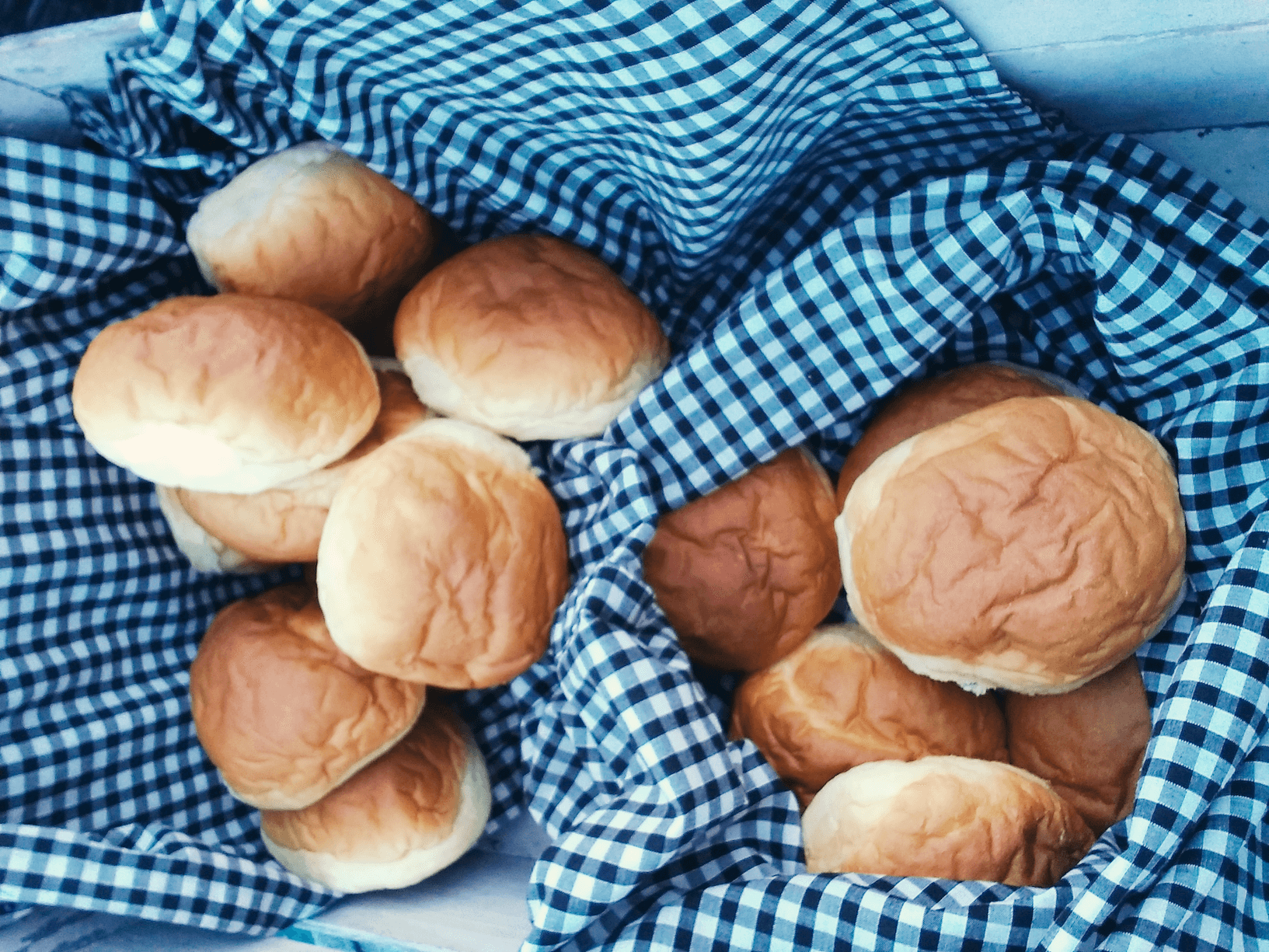 Brioche Rolls in a Basket with Gingham Cloth