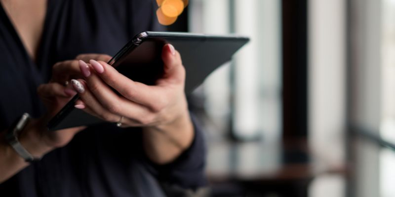 A retail owner staff holding a mobile POS System to do inventory