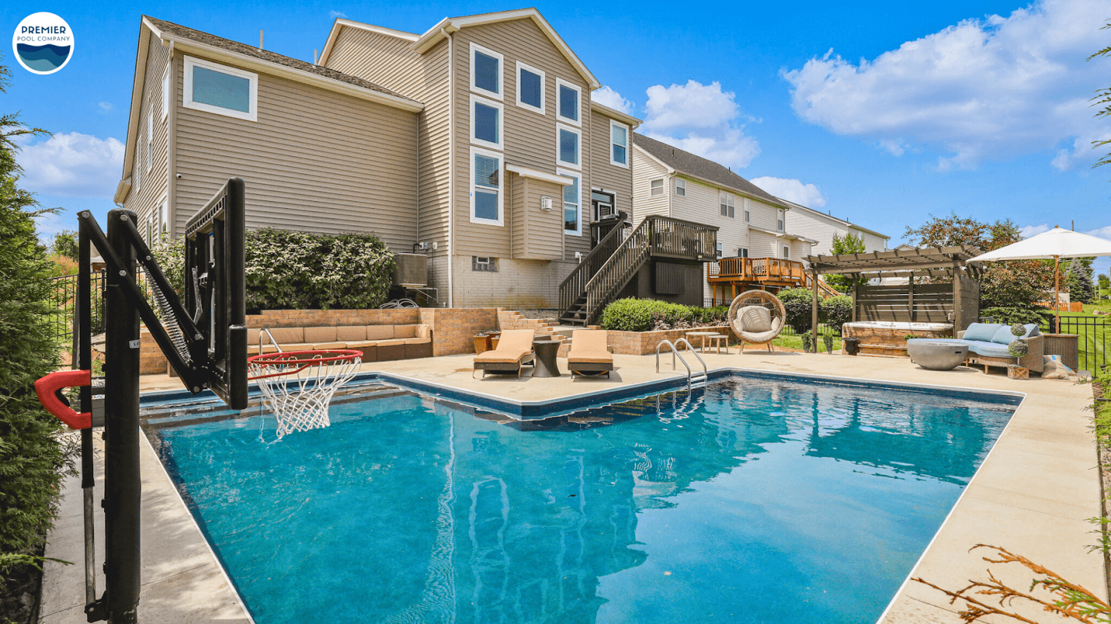 Vibrant pool tile colors in emerald green and fiery red with natural stone decking, showcasing bold design trends in Central Ohio
