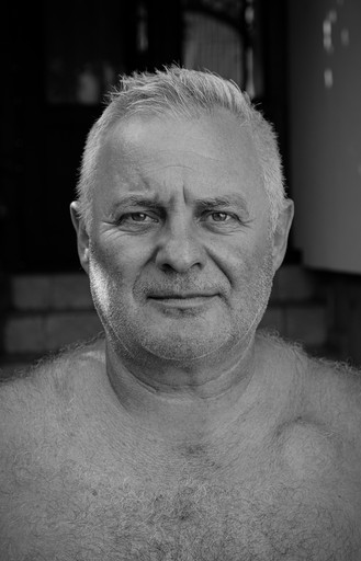 a black and white photo of a man without a shirt