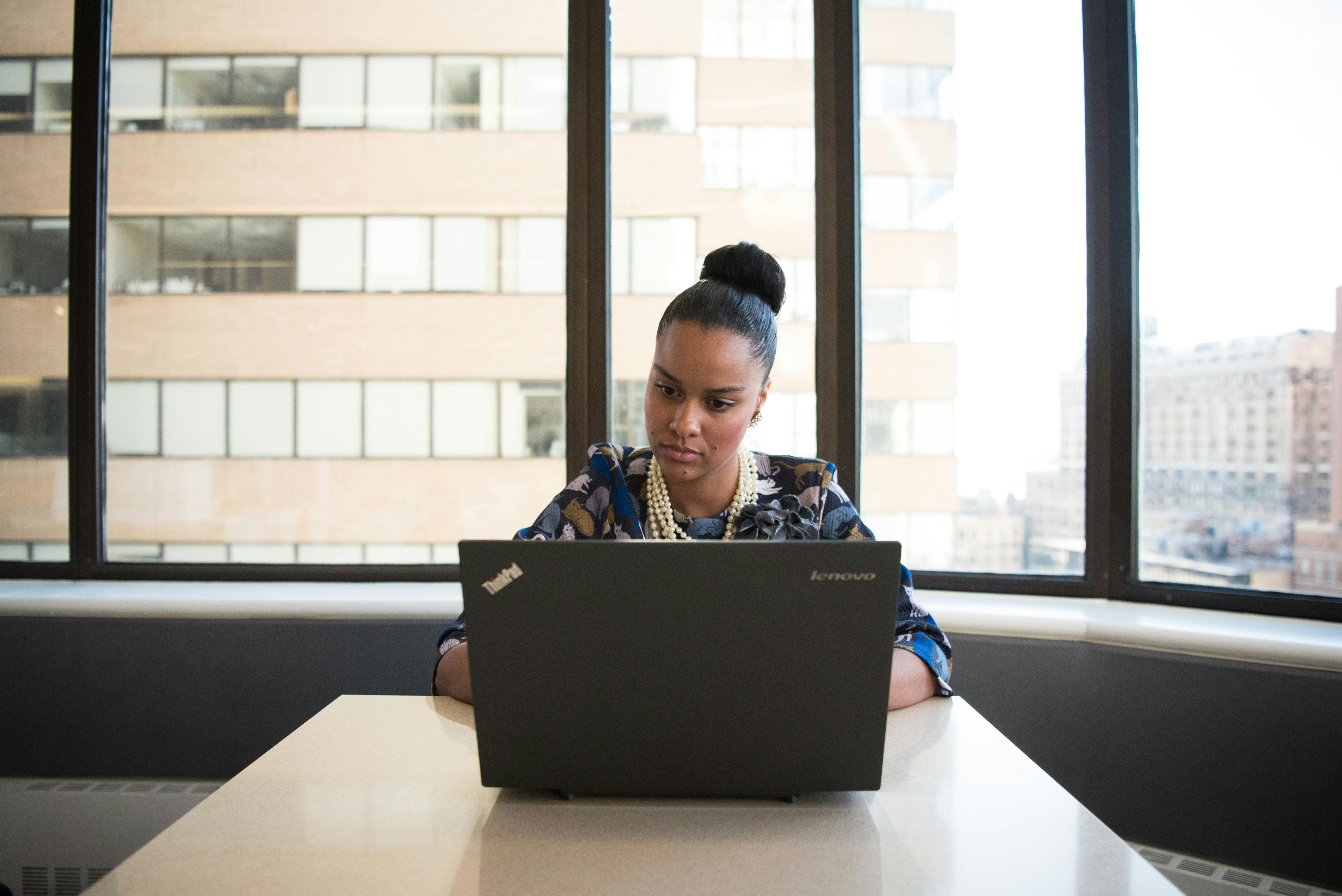 Woman searching about low income high mortgage on laptop