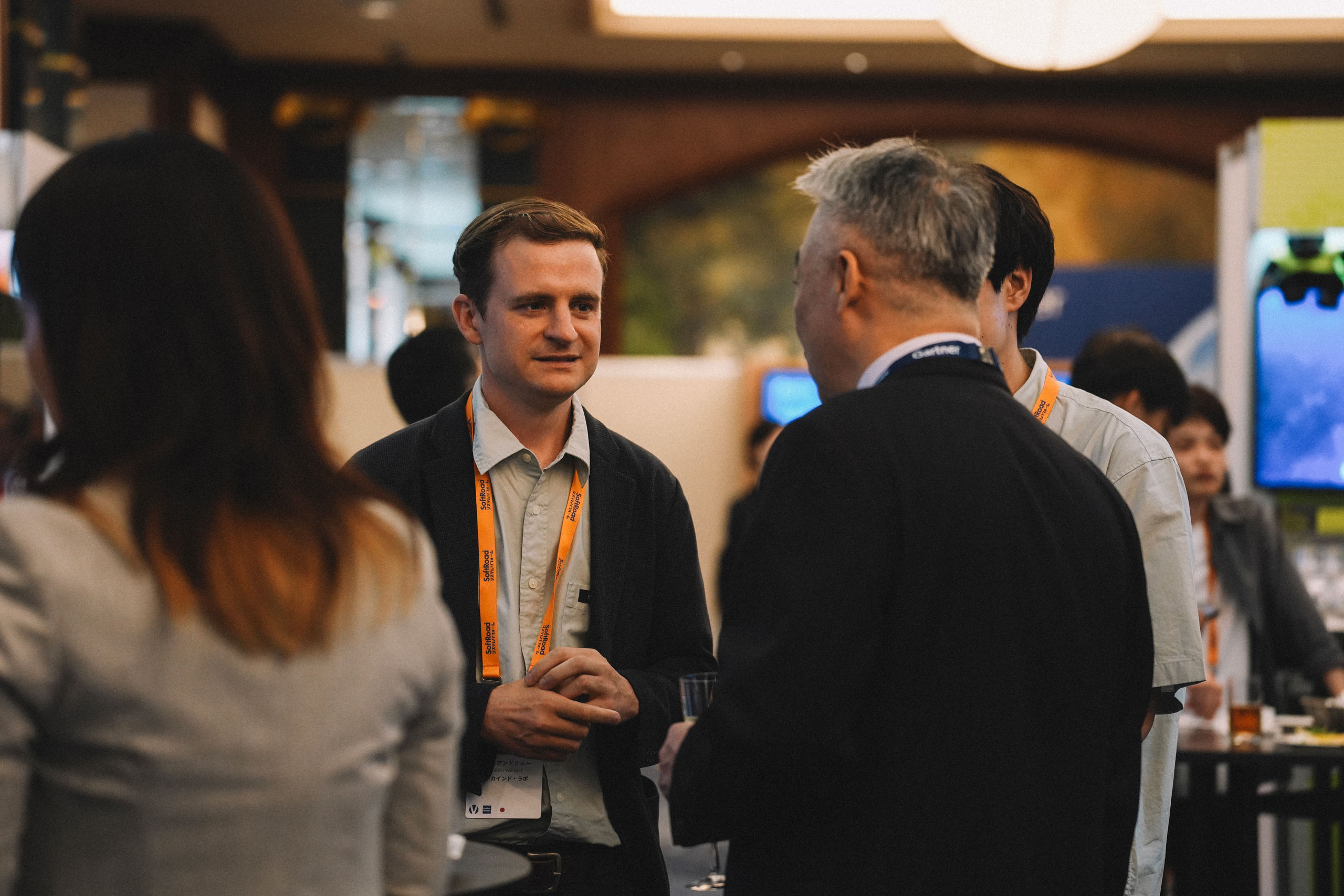 Bekind Labs team member networking, exchanging business cards, and conversing with Gartner representatives and attendees at the Gartner Summit 2026 reception.
