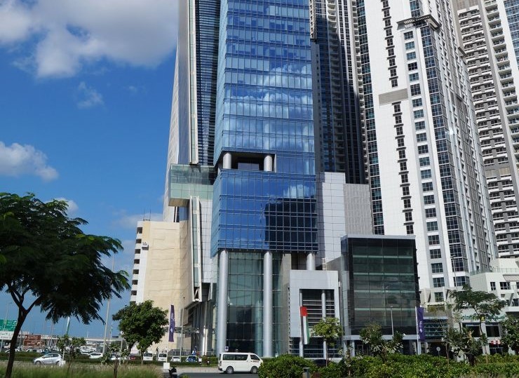 Modern blue glass facade of Vision Tower in Business Bay, a prime location for real estate investment.