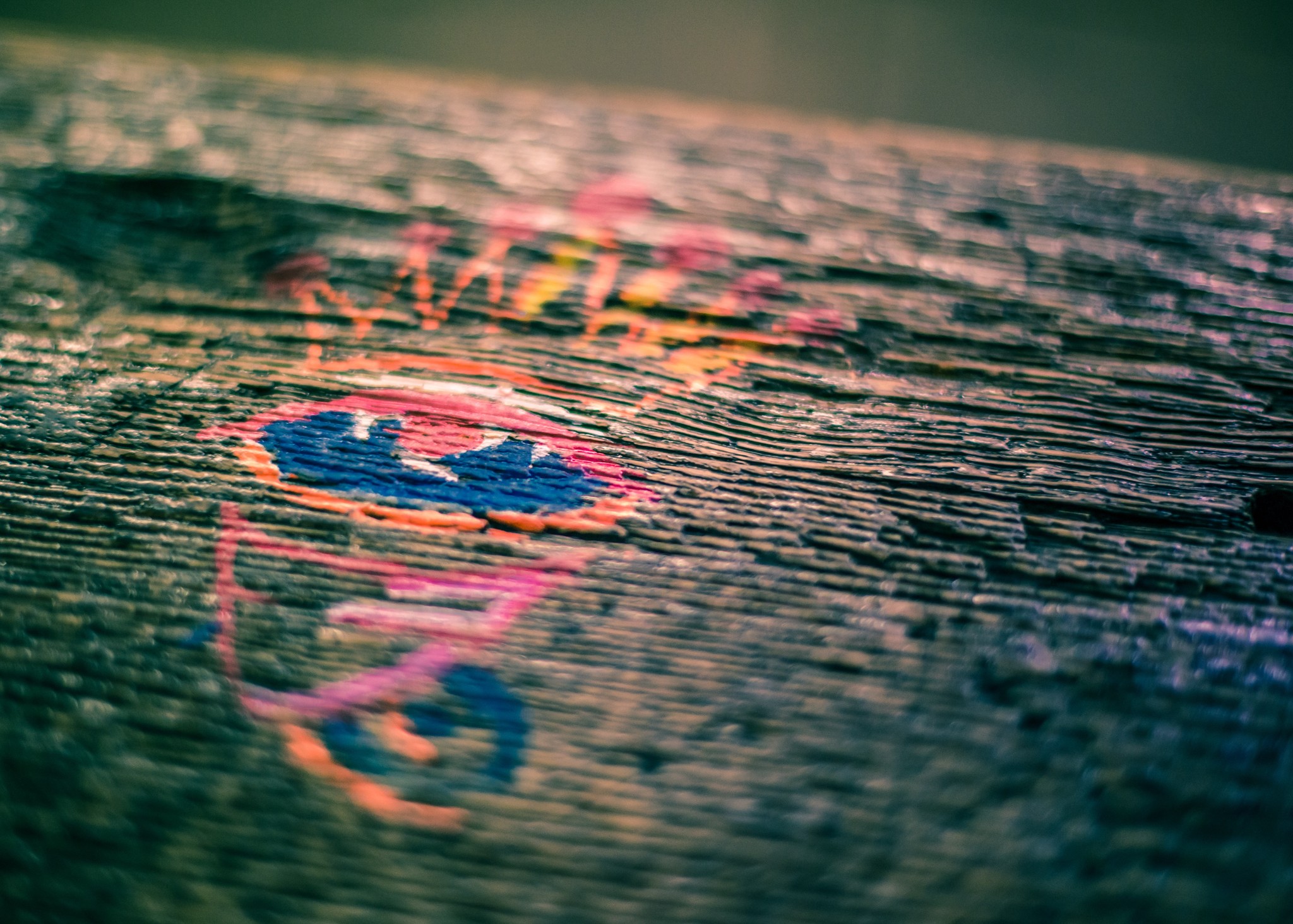 Painted hyroglyph on bench at a G train station in Clinton Hill, NY