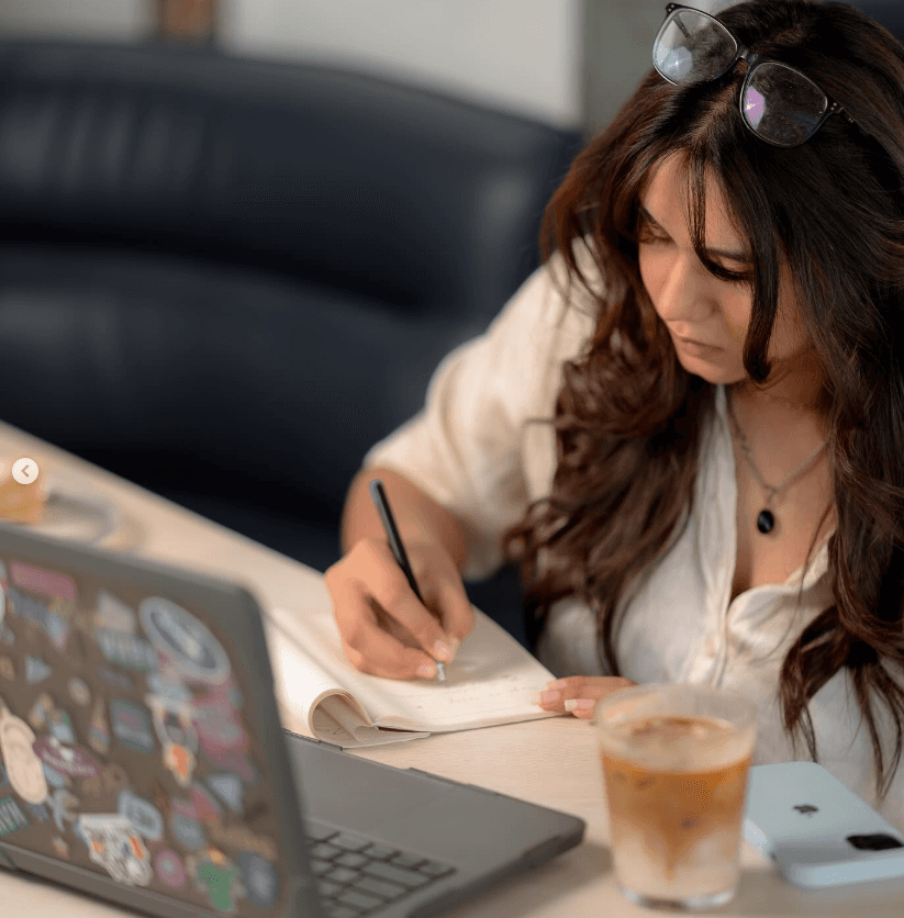 man filming on beach