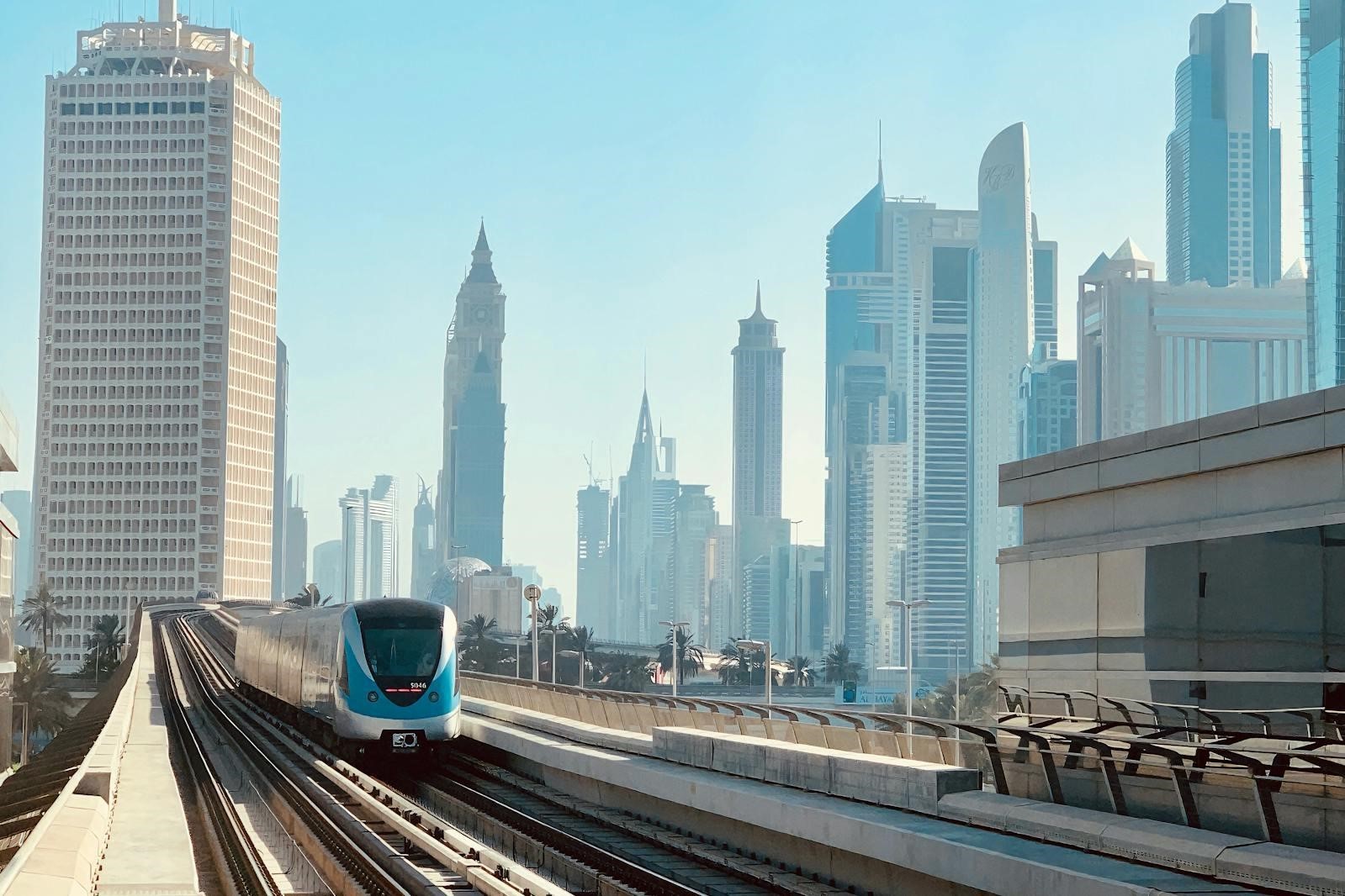 Modern Dubai Metro transit line near high-rise commercial buildings in Nad Al Hamar area.