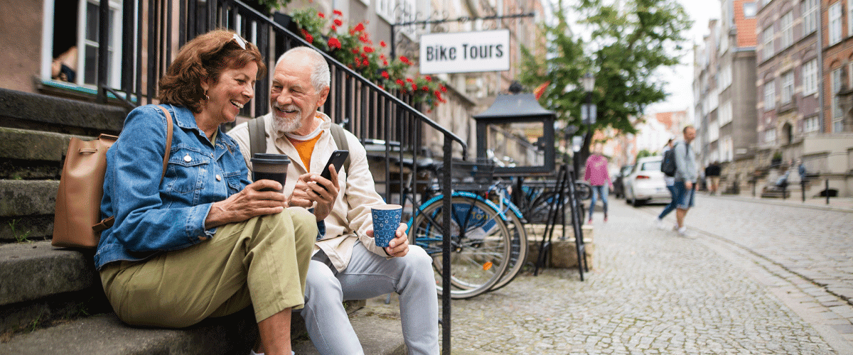 Mature Couple with hearing loss having coffee before their bike tour