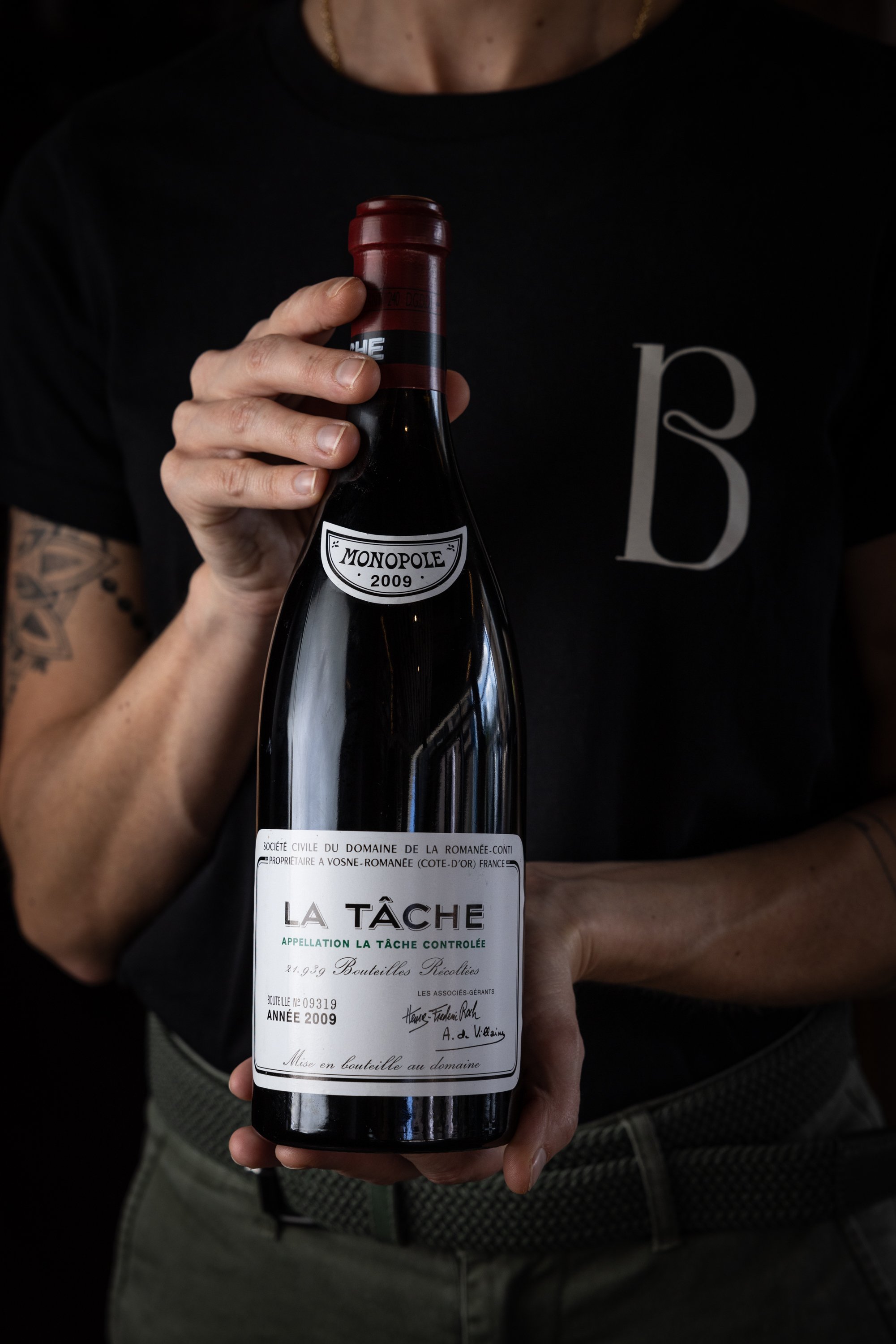 Bos Staff Member Holding Wine Bottle