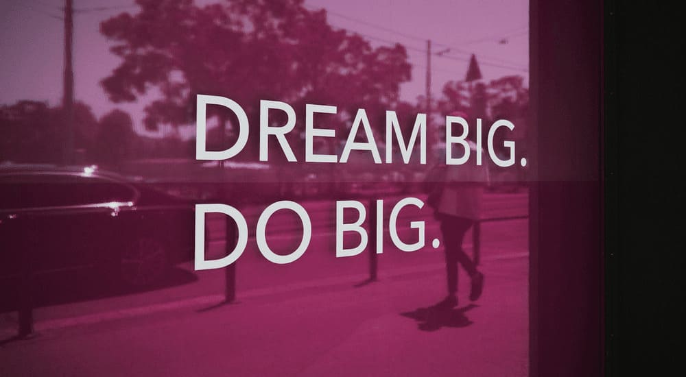 Team collaborating on laptops in bright workspace