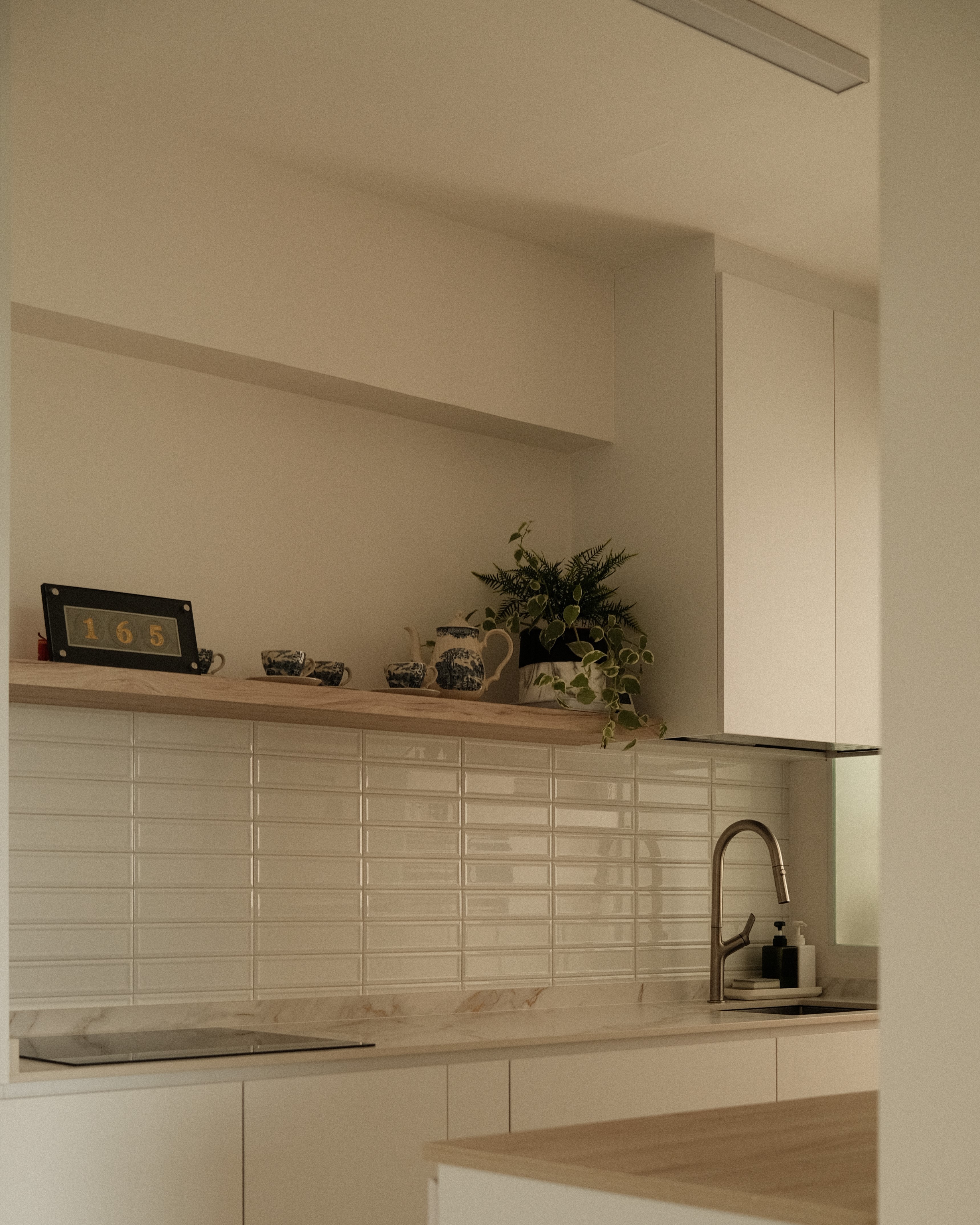 Bright kitchen with neutral palette, open shelving, and indoor plant, contemporary renovation by Persqft Singapore