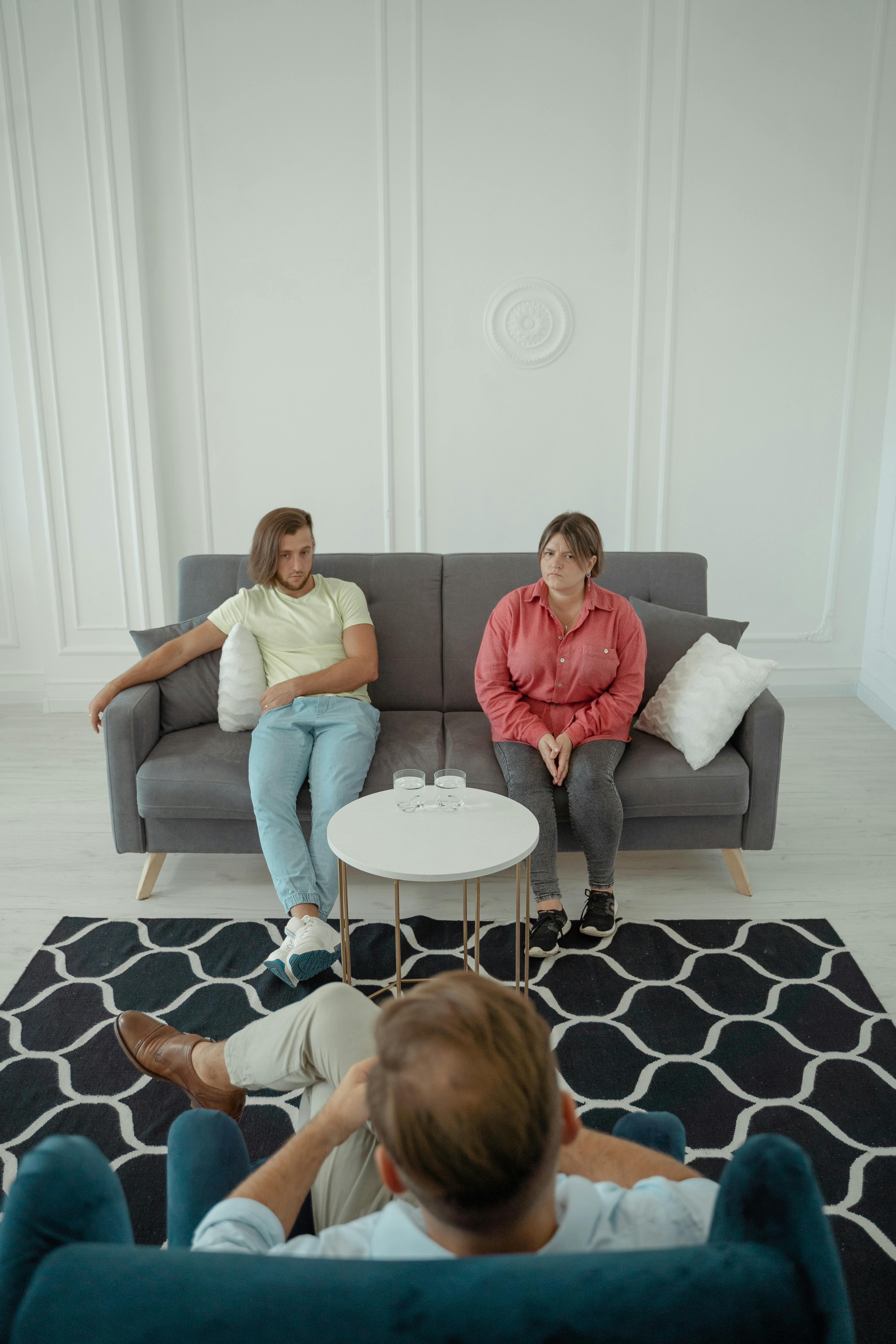 A calm therapy or conversation scene, with two people sitting across from each other.