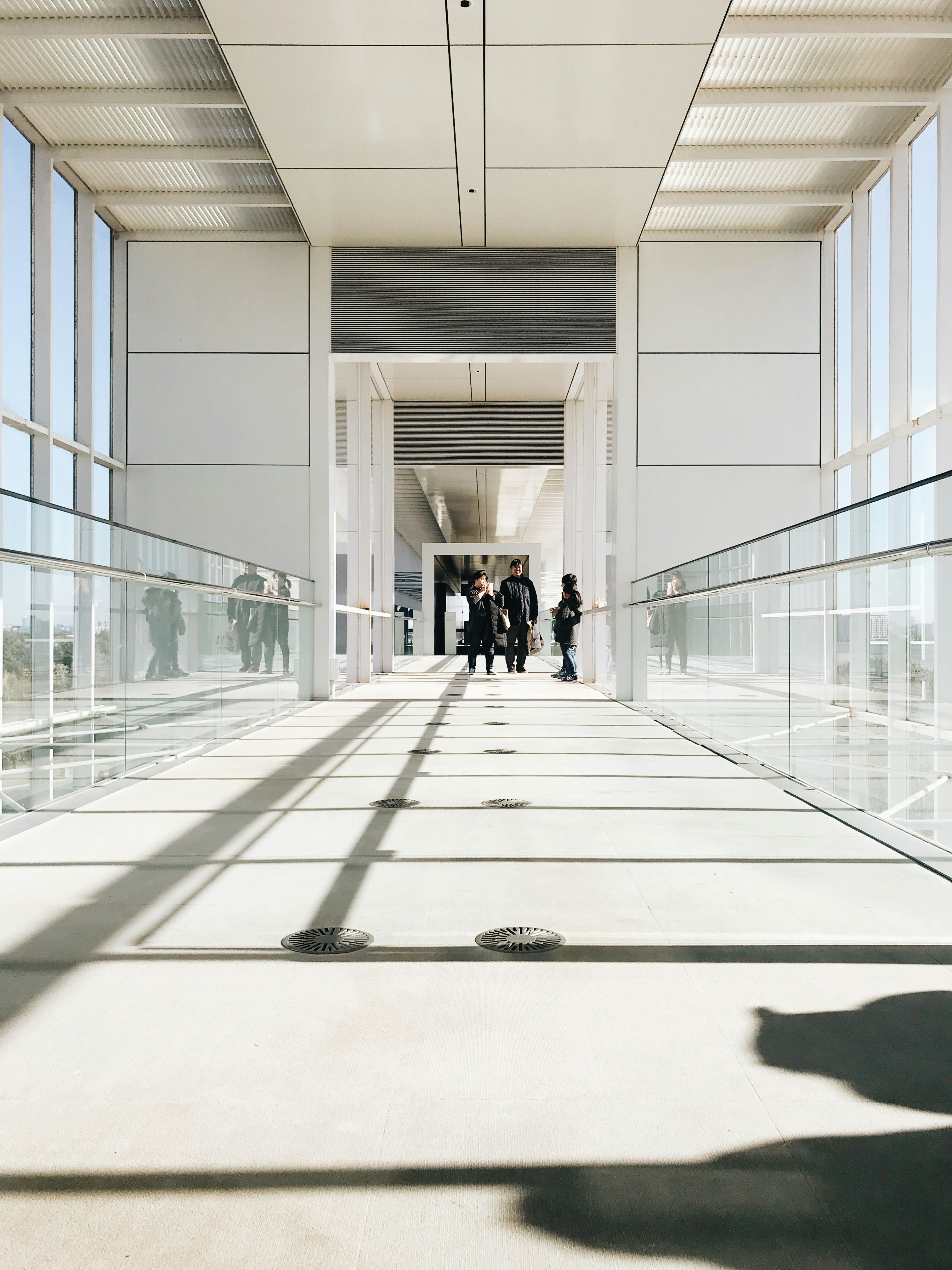 person in black jacket walking on hallway