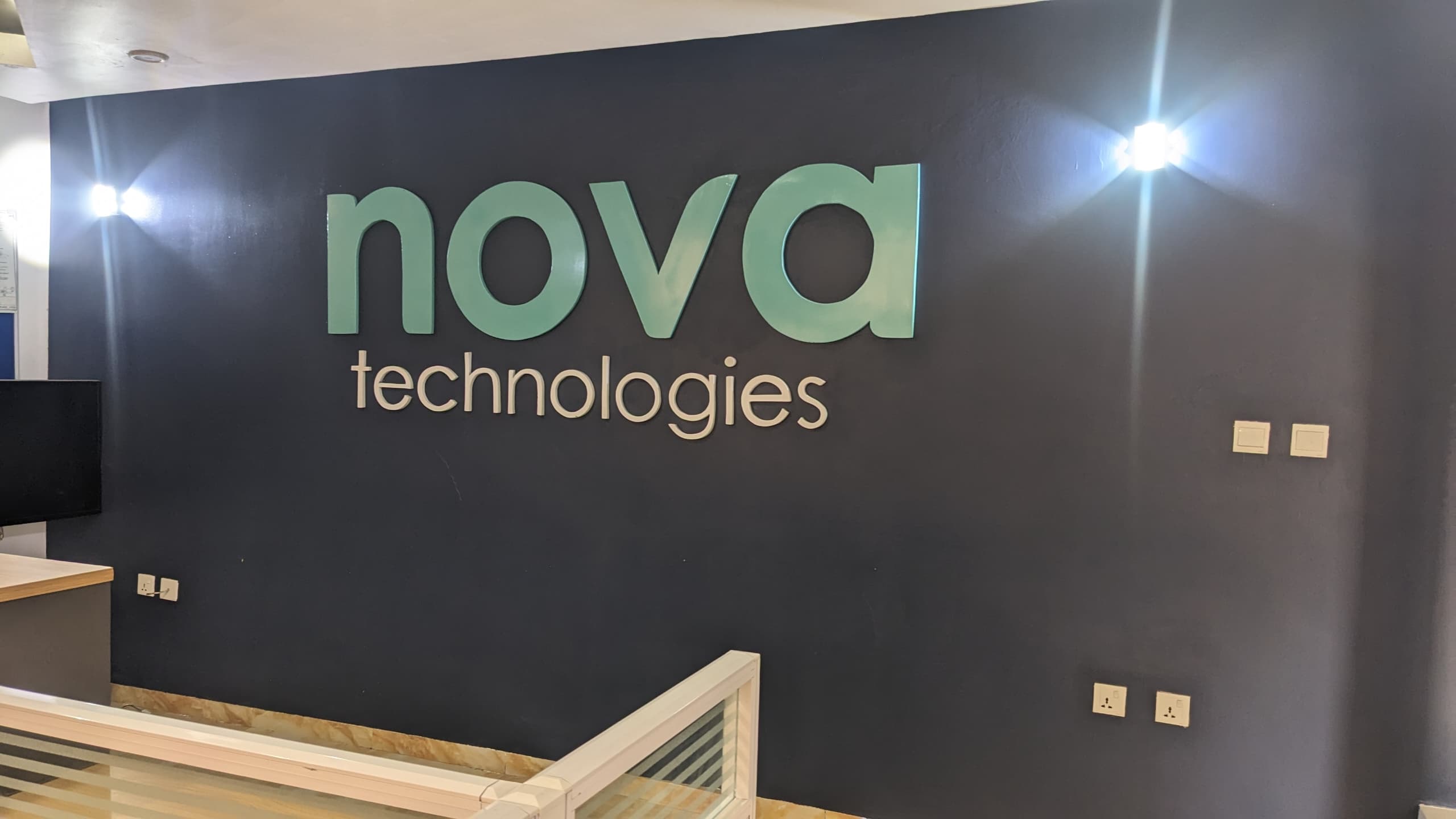 Aerial view of a winding road surrounded by dense green and yellow trees, showcasing nature’s vibrant colors.