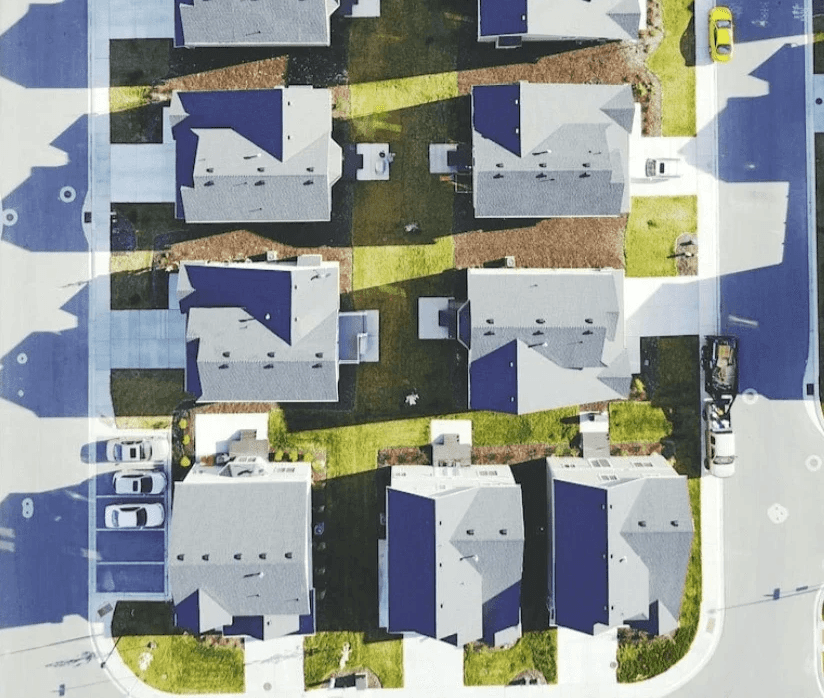Rows of suburban houses seen from above.