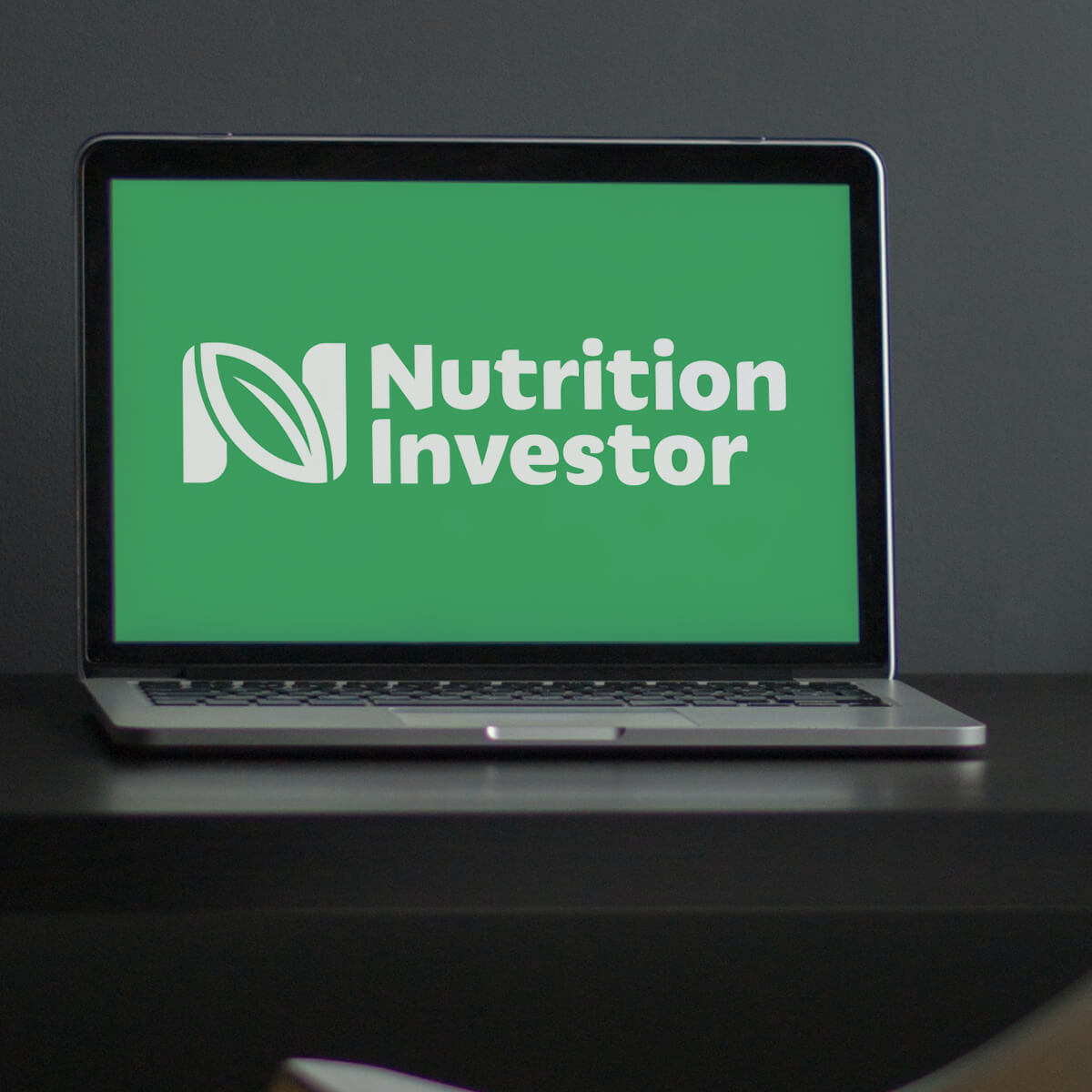 The NutritionInvestor logo in white on a green background presented on a laptop