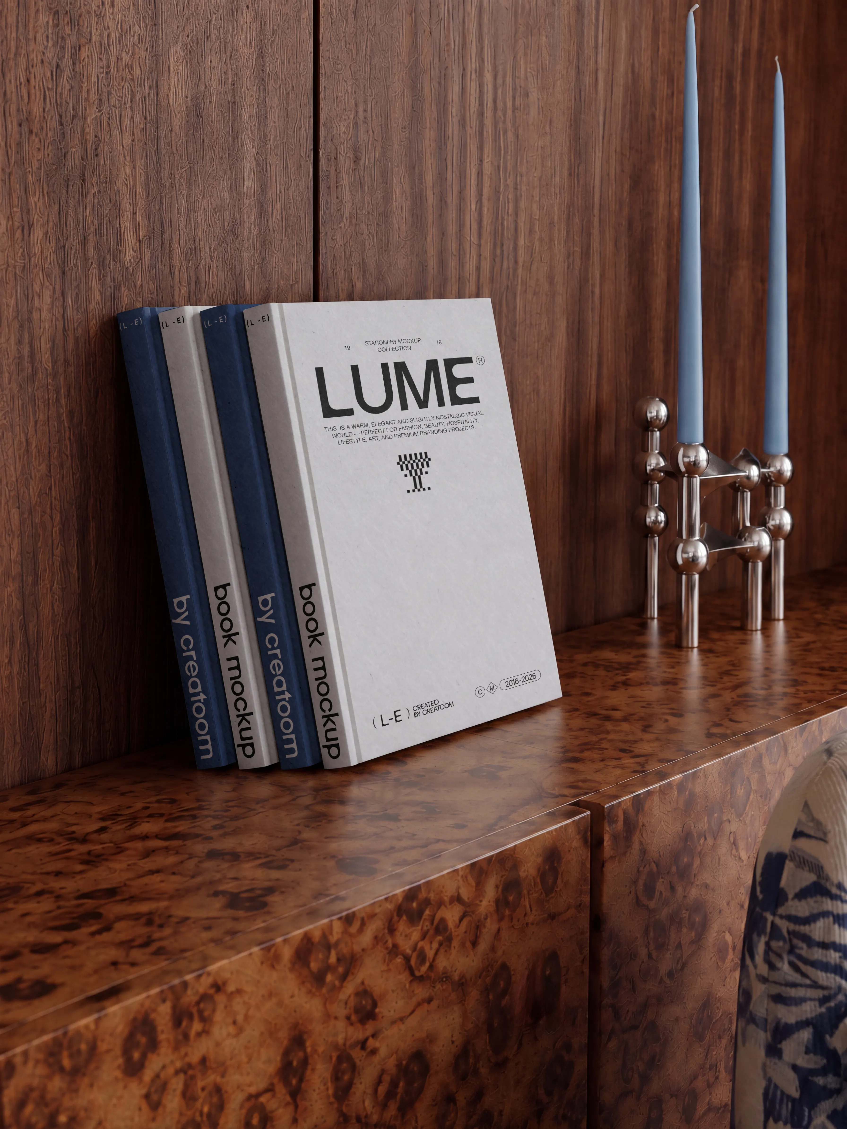 Stacked Lume books on a wooden console
