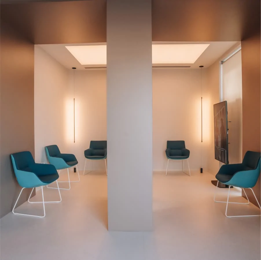 Golden cross atop a domed building with blue sky.