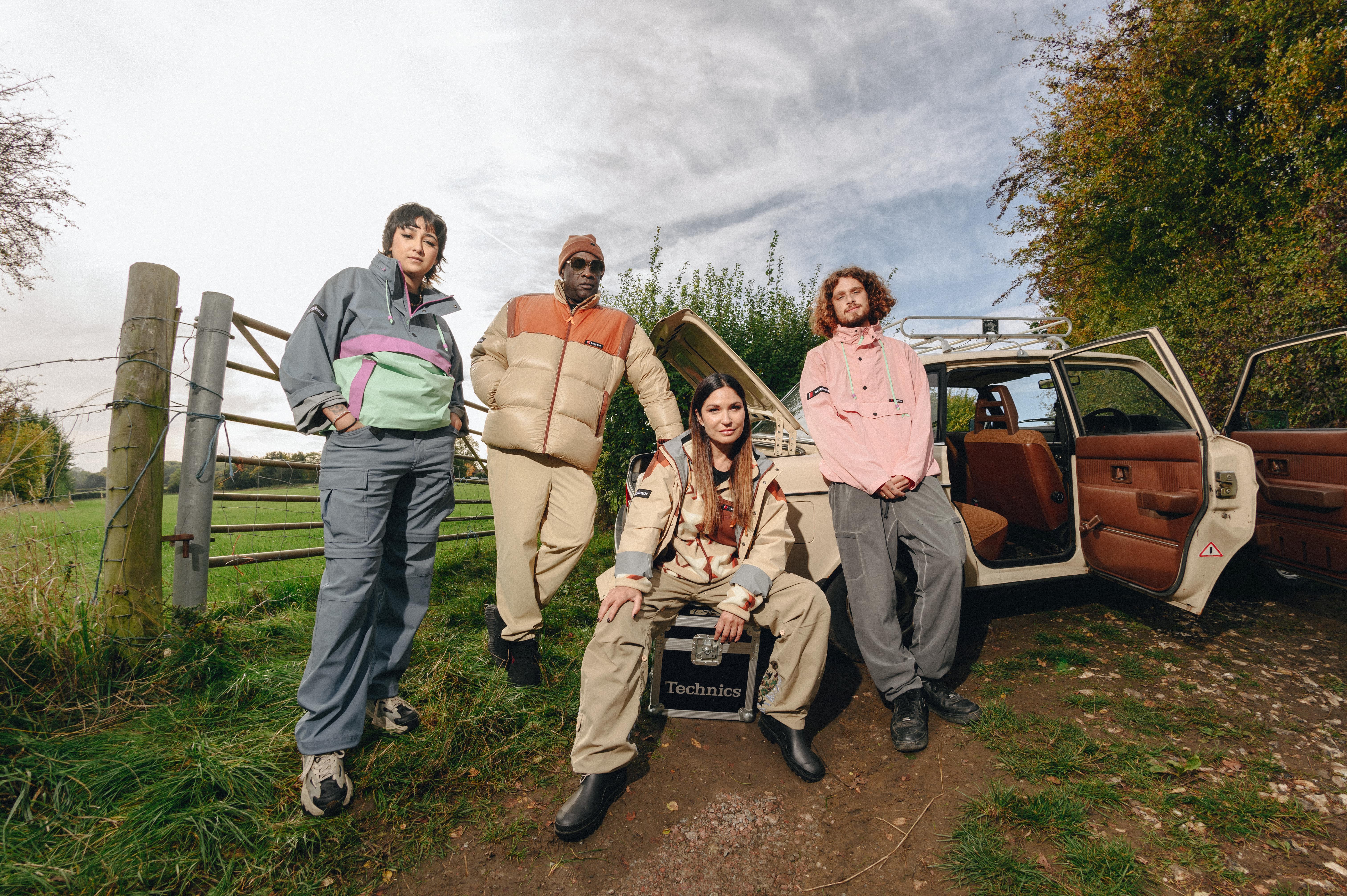 A close-up of a hand wearing multiple decorative rings against a blue background.