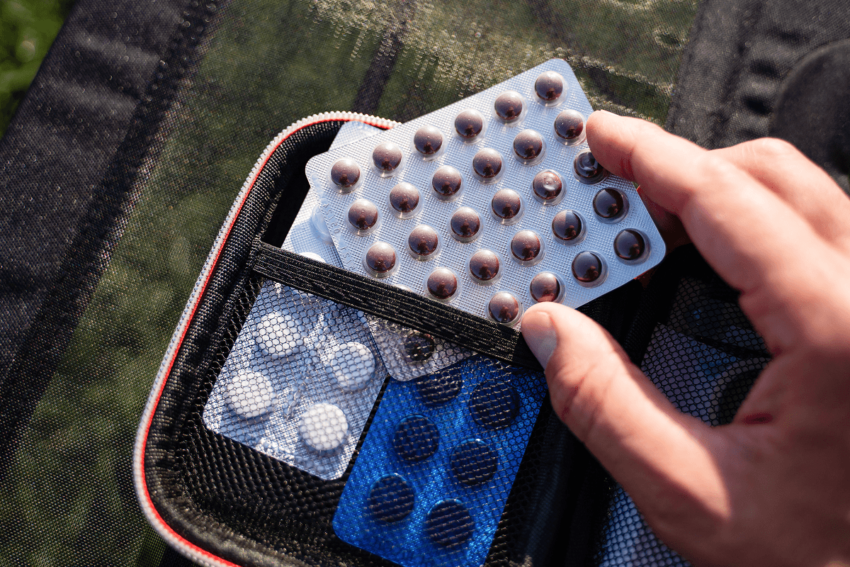 Close-up of a weekly pill organiser with medication