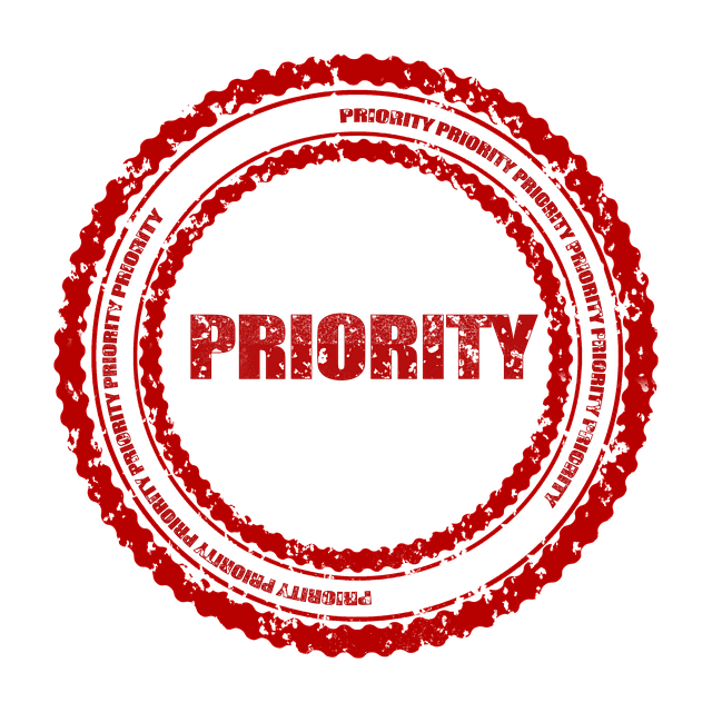 Red rubber stamp mark with the word priority in the middle