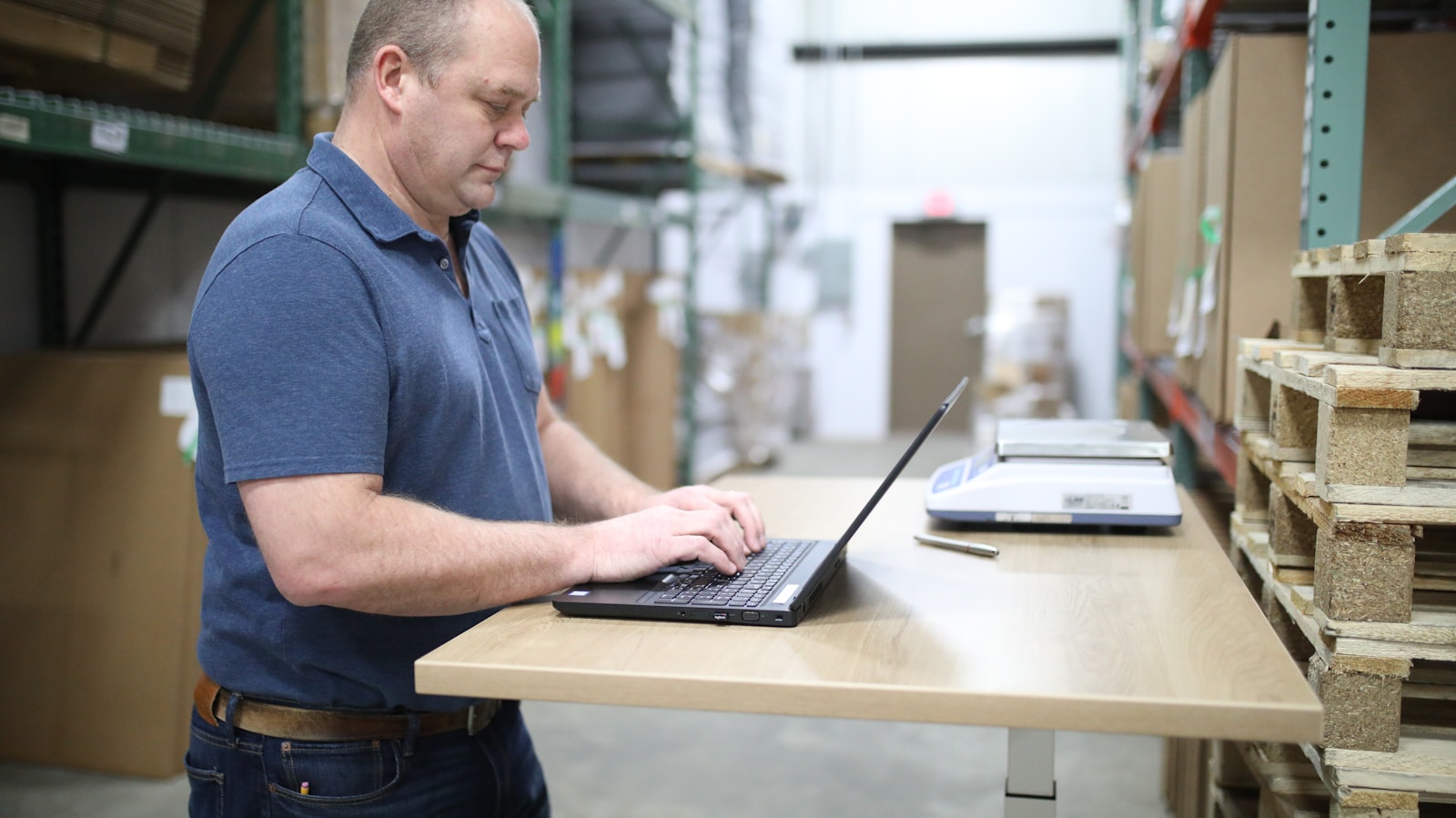 Warehouse team reviewing product data on a laptop