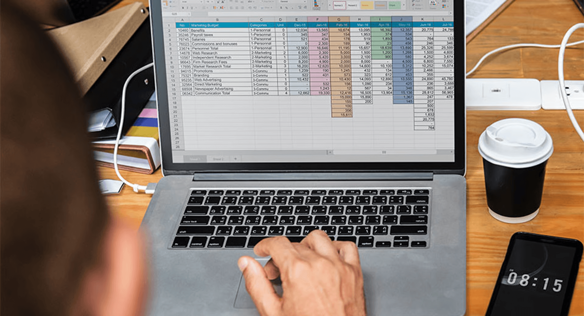 Person using spreadsheet on laptop - How to Make a Financial Report in Excel