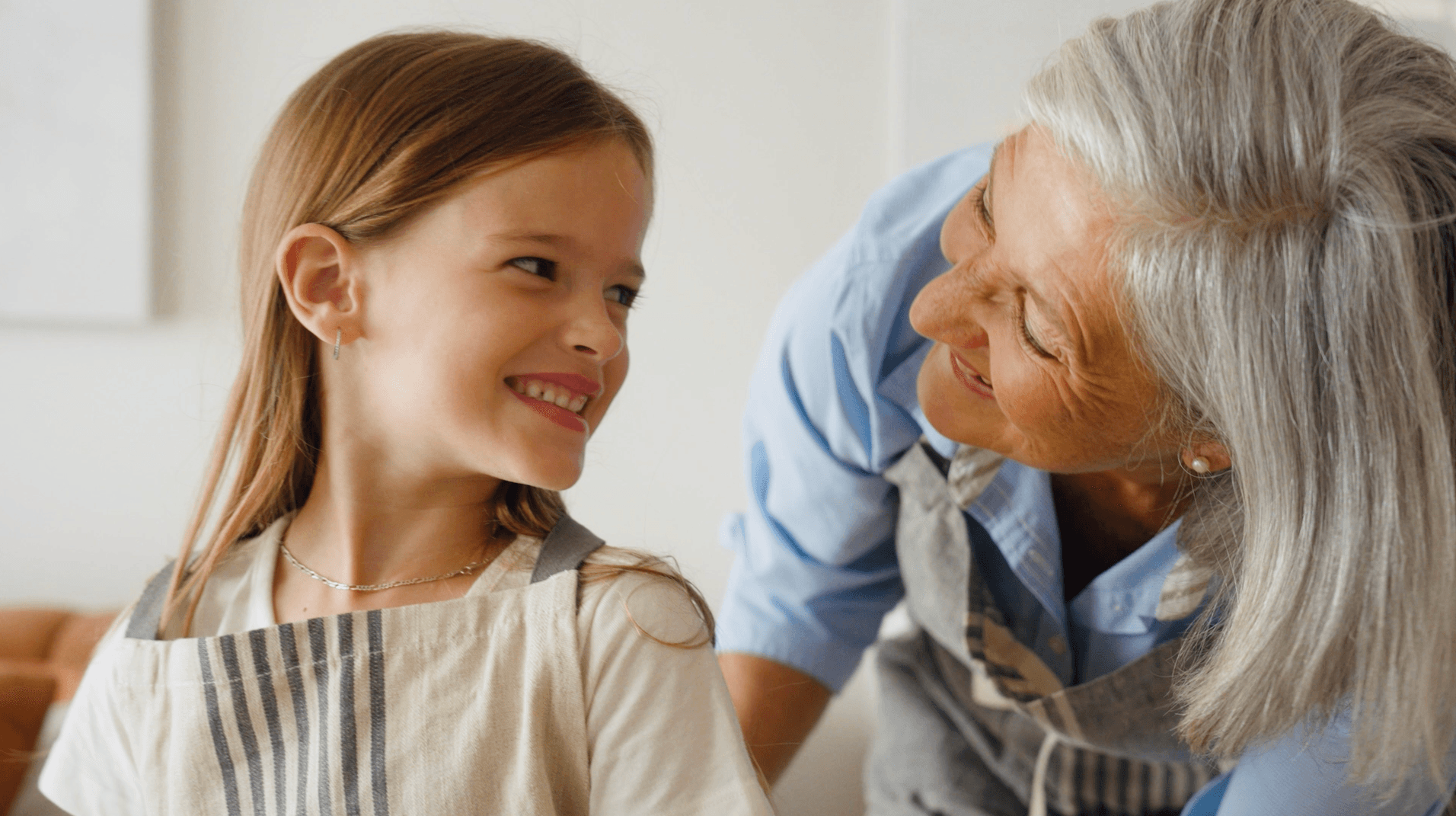 Young girl and an older lady smiling at each other
