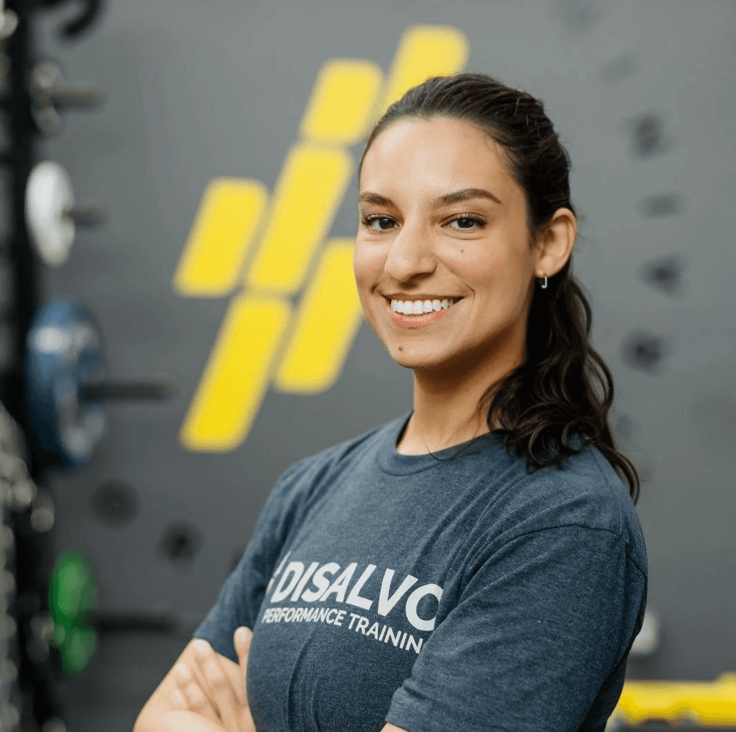 Previous Personal training client, Bianca posing in her own personal training gym ass a coach