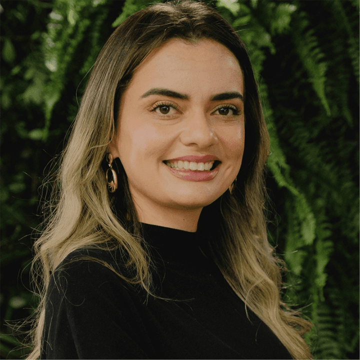 smiling woman wearing white and black pinstriped collared top