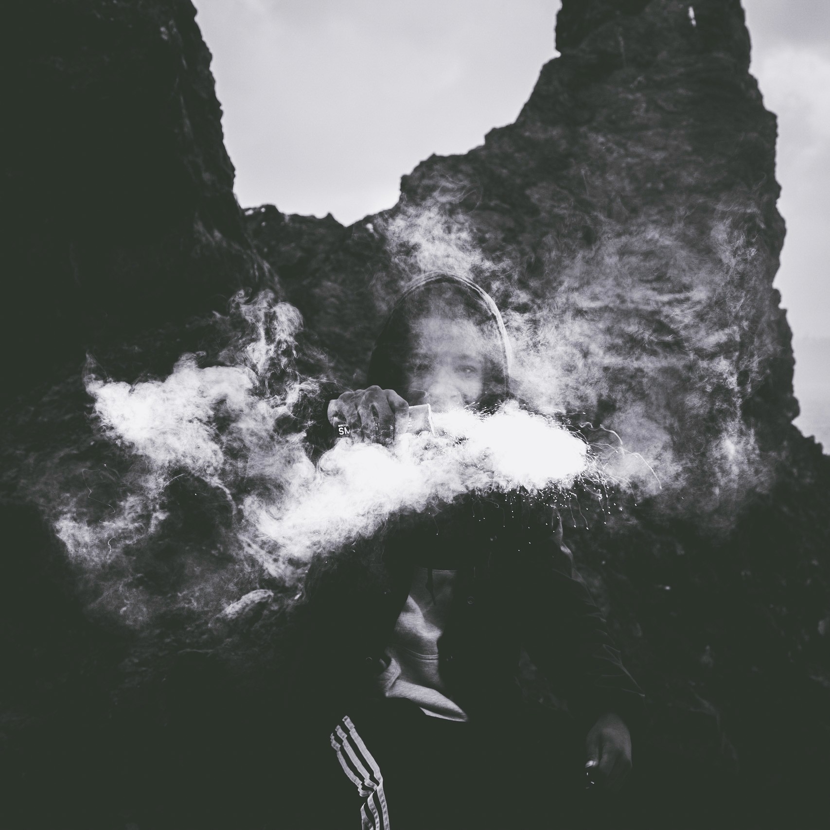 Man holding a flair with smoke all around