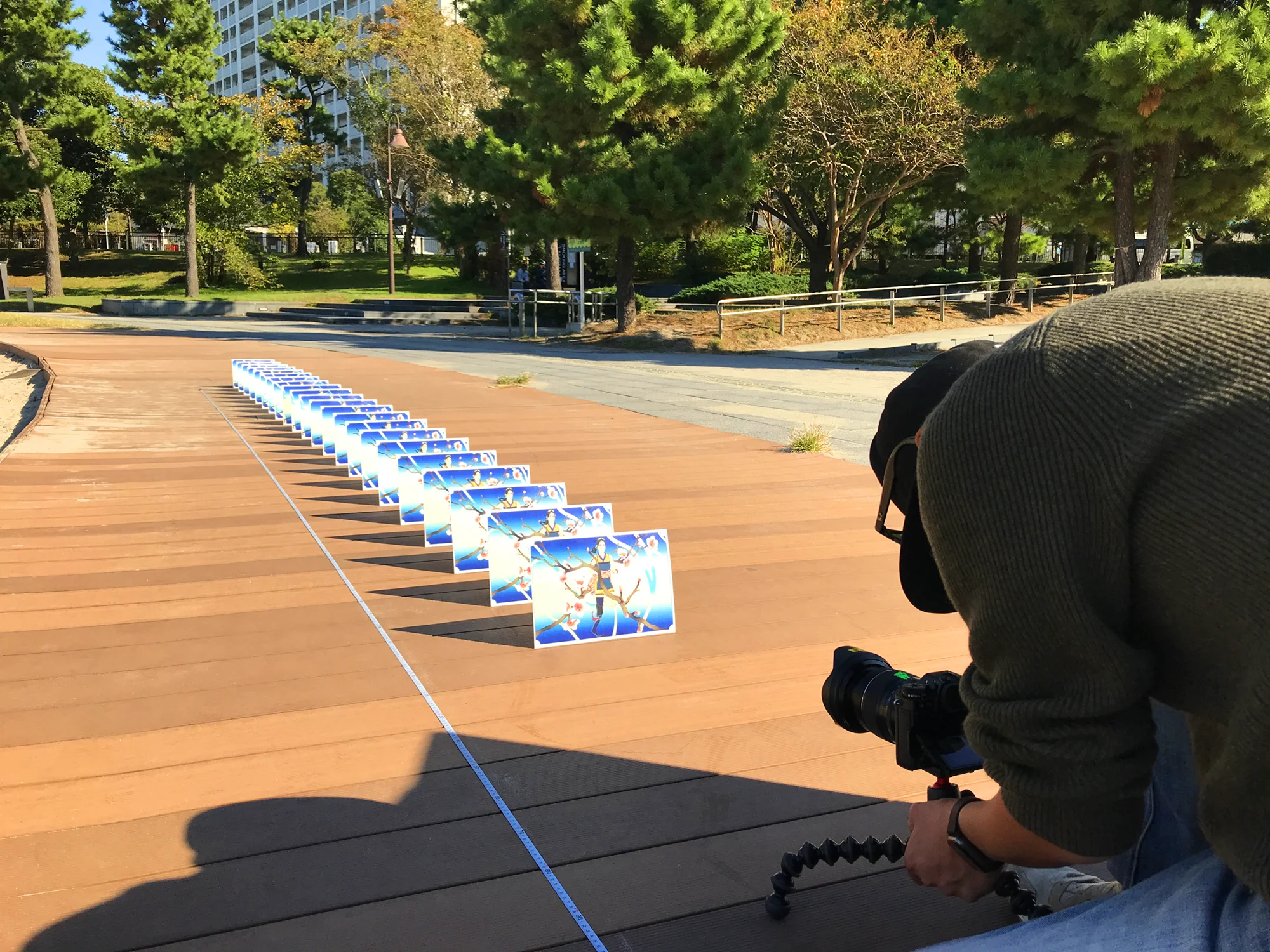 Behind-the-scenes photo from Bridgestone Chase Your Dream showing printed artwork panels arranged outdoors for filming.