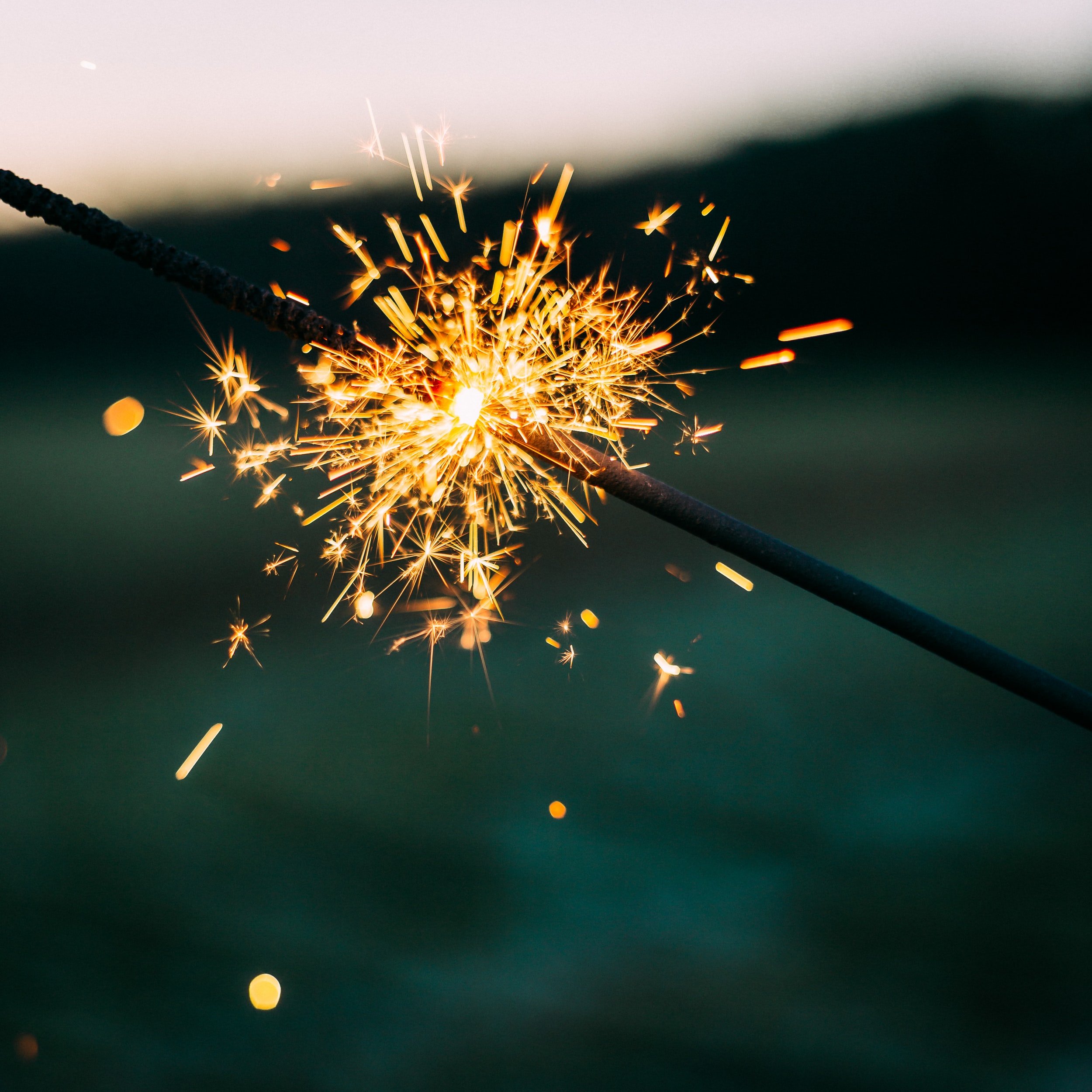 A sparkler burning against a dark background