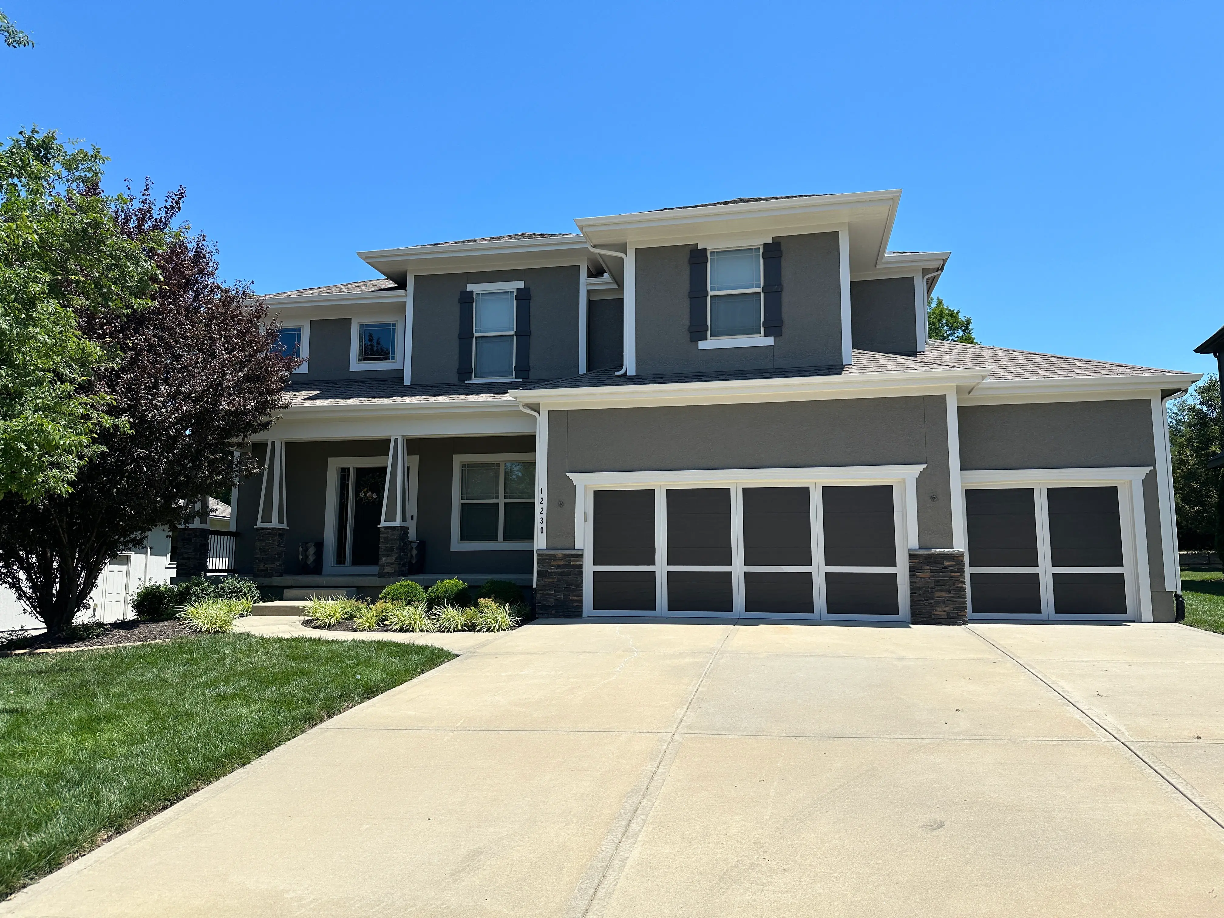 An image of a freshly painted grey house with brown and white accents.