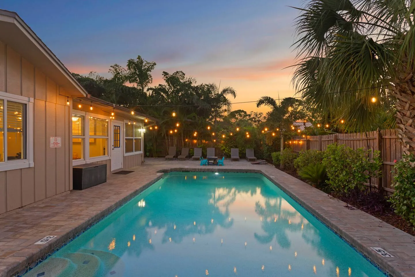 Pool at twilight with string lights at Sarasota Beach Bungalow, Bradenton, Florida