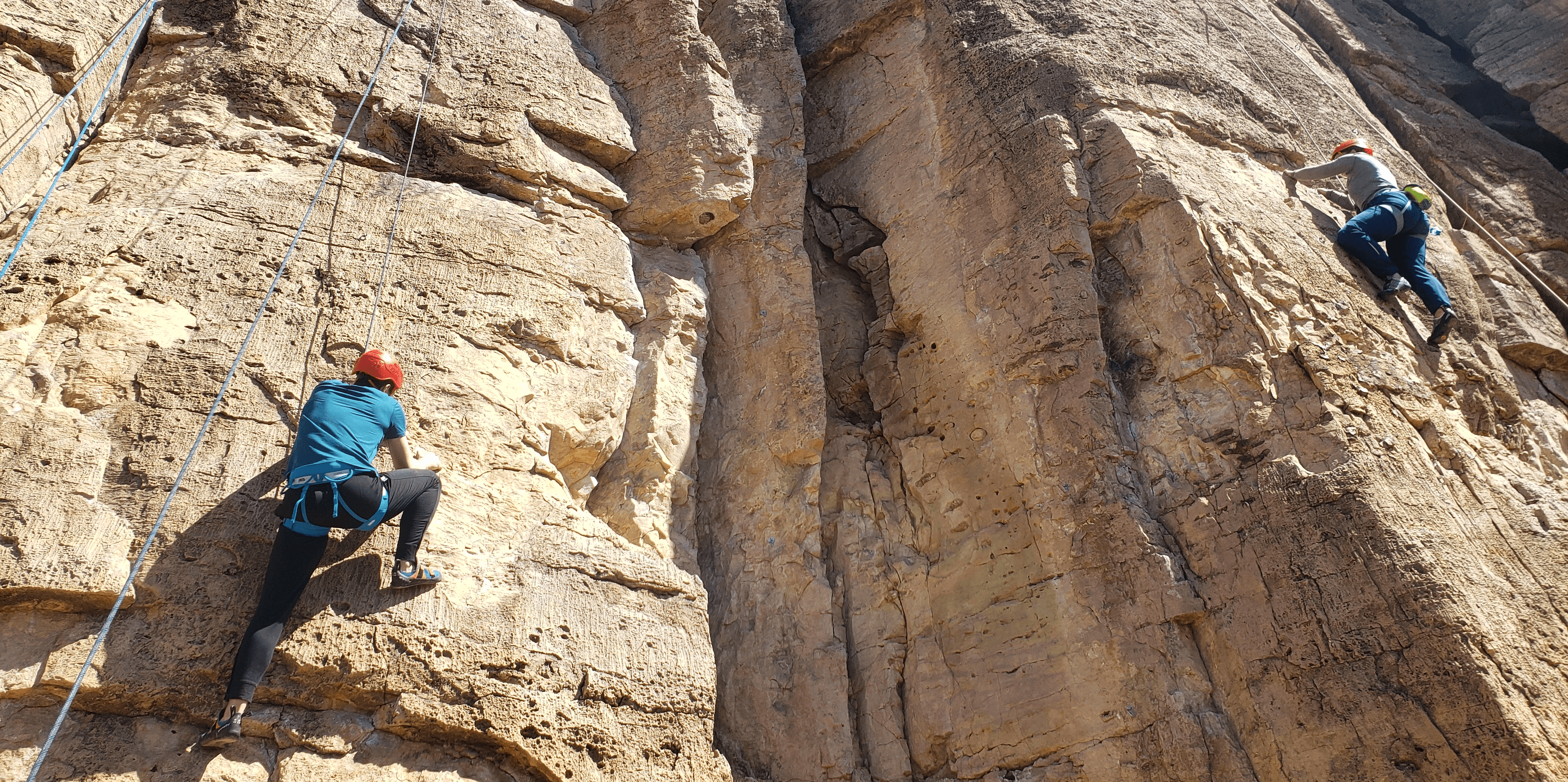 Climbers enjoy late winter sunshine in T shirts at Shelf Road