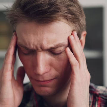 a man holding his hands to his ears
