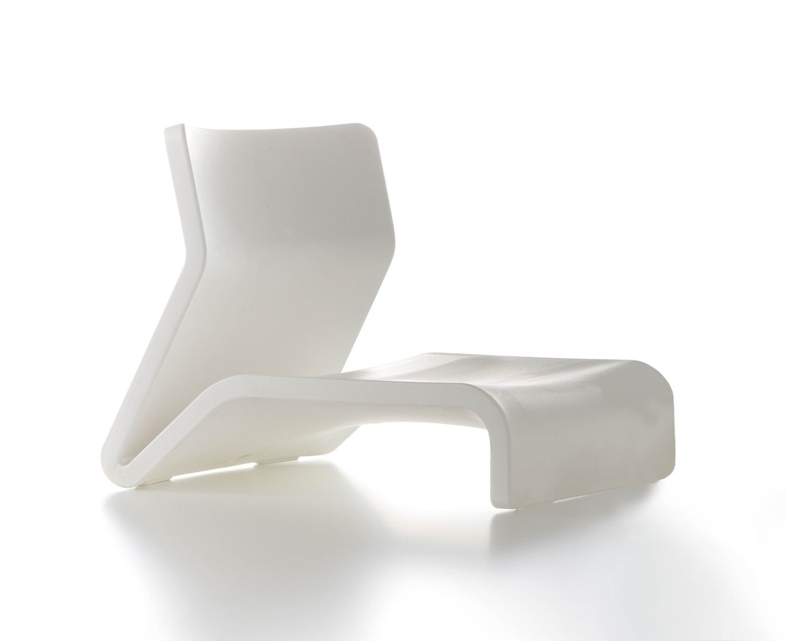 White Clip Chair: Sculptural white lounge chair with a unique ergonomic silhouette, captured with high-key studio photography.