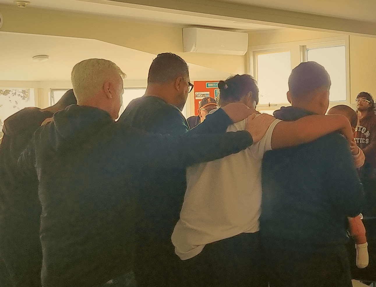 People huddling in prayer