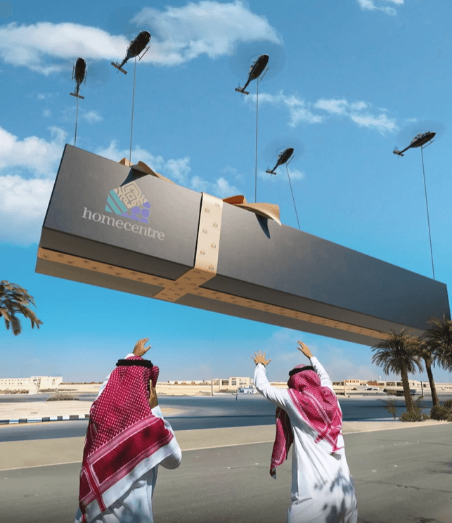 A high-detail shot of the branded Homecentre box being lowered by helicopters